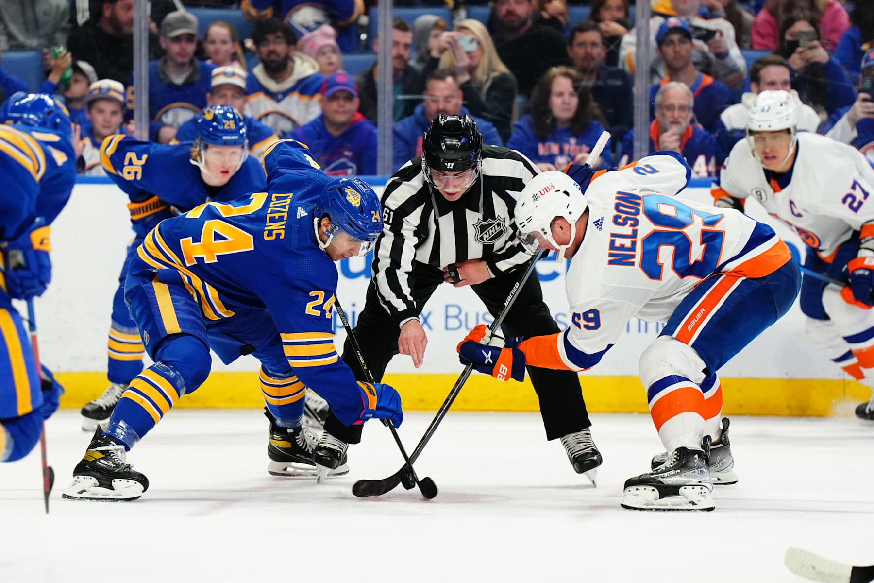 Buffalo Sabres center Dylan Cozens (left) and New York Islanders center Brock Nelson. 