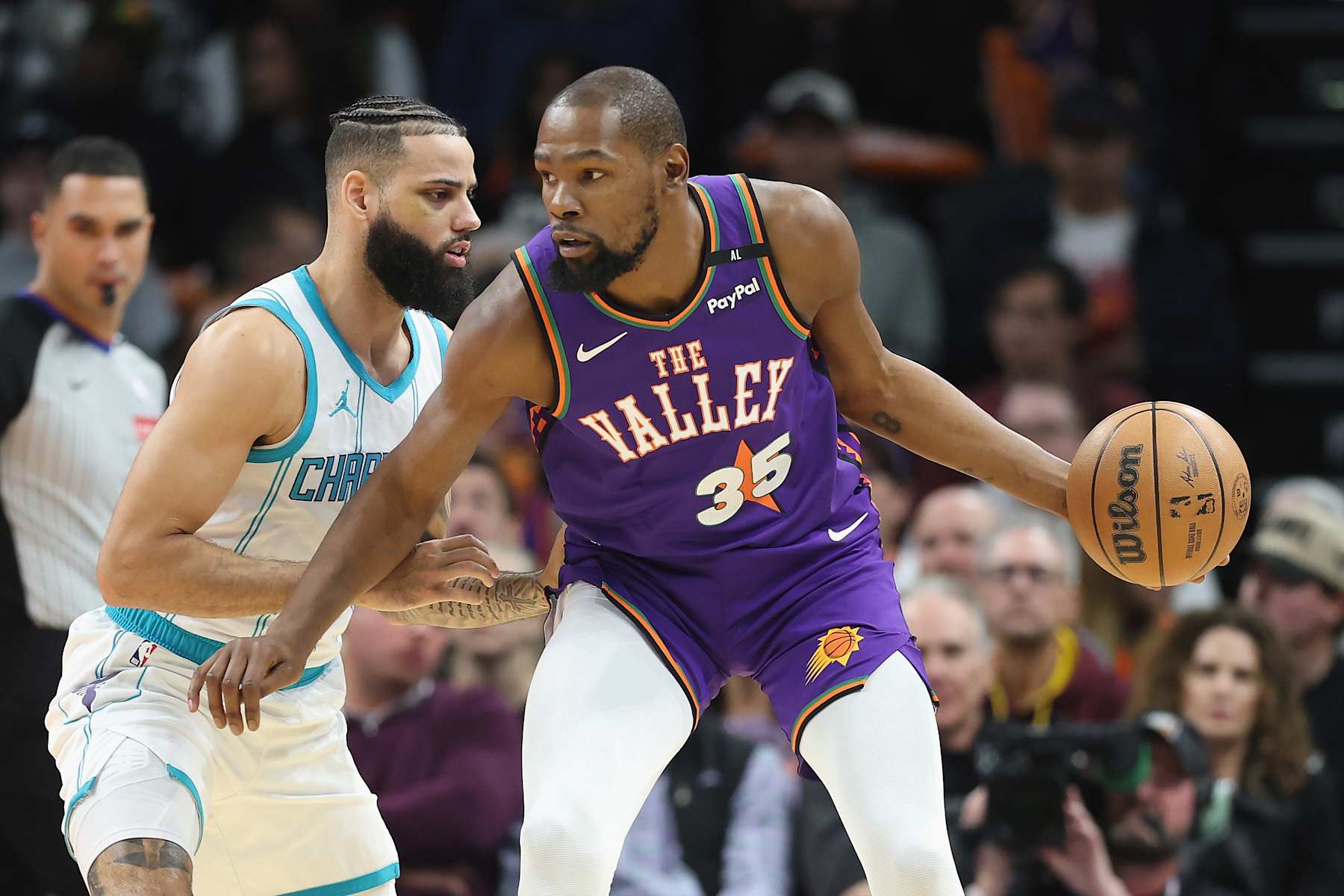 PHOENIX, ARIZONA - JANUARY 12: Kevin Durant #35 of the Phoenix Suns handles the ball under pressure from Cody Martin #11 of the Charlotte Hornets during the second half of the NBA game at Footprint Center on January 12, 2025 in Phoenix, Arizona. NOTE TO USER: User expressly acknowledges and agrees that, by downloading and or using this photograph, User is consenting to the terms and conditions of the Getty Images License Agreement.  (Photo by Christian Petersen/Getty Images)