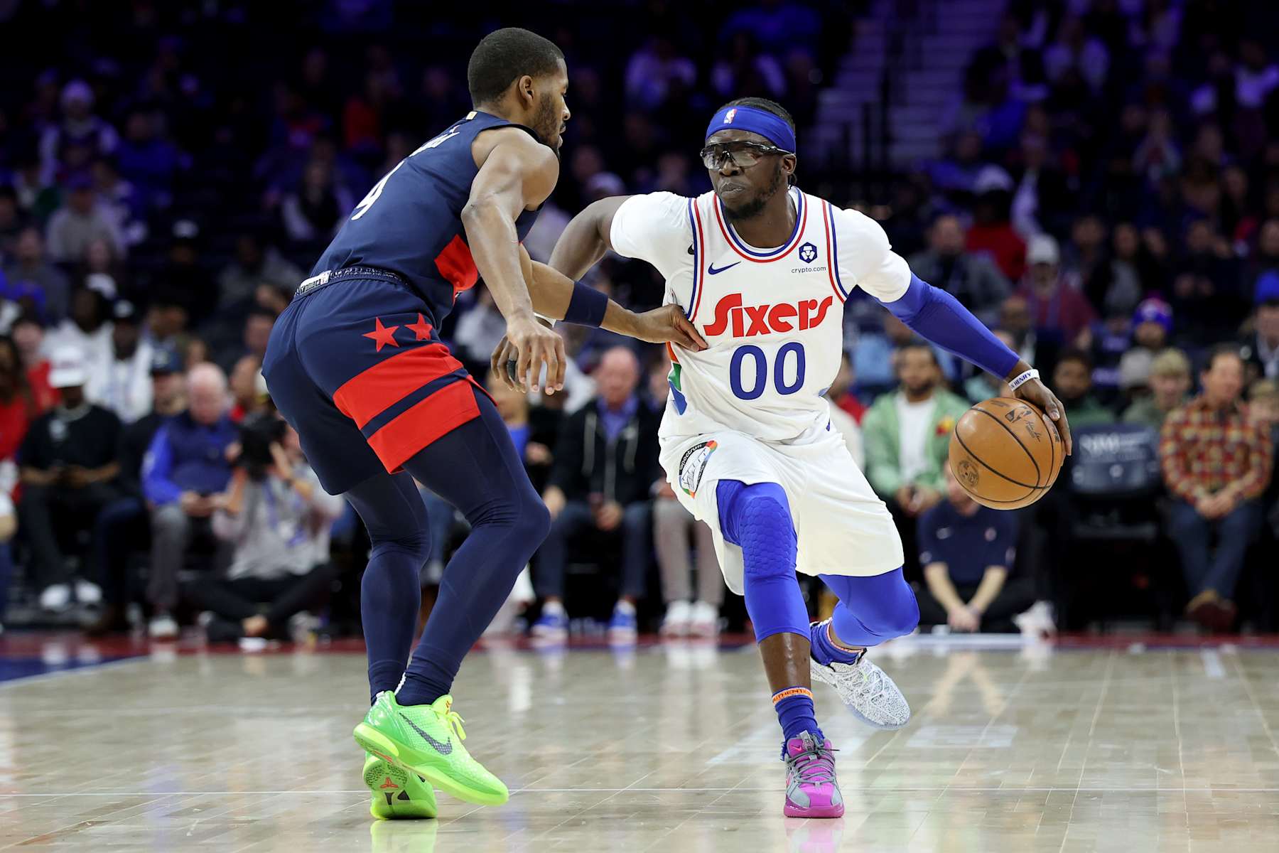 PHILADELPHIA, PENNSYLVANIA - JANUARY 08: Reggie Jackson #00 of the Philadelphia 76ers drives against Jared Butler #4 of the Washington Wizards during the first half at the Wells Fargo Center on January 08, 2025 in Philadelphia, Pennsylvania. NOTE TO USER: User expressly acknowledges and agrees that, by downloading and or using this photograph, User is consenting to the terms and conditions of the Getty Images License Agreement. (Photo by Emilee Chinn/Getty Images)