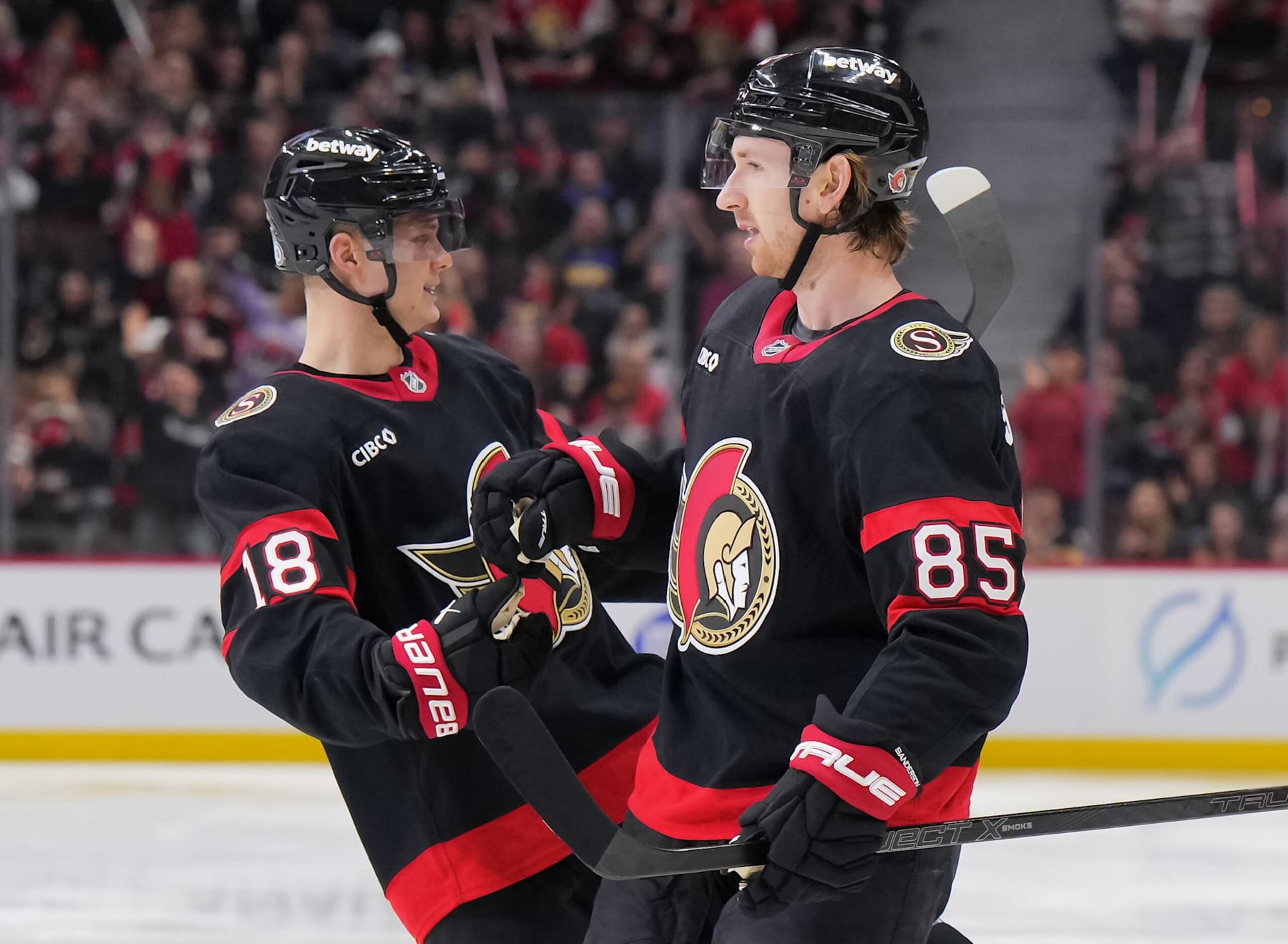 OTTAWA, CANADA - FEBRUARY 1: Jake Sanderson #85 of the Ottawa Senators celebrates his third period goal against the Minnesota Wild with teammate Tim Stützle #18 at Canadian Tire Centre on February 1, 2025 in Ottawa, Ontario, Canada.  (Photo by André Ringuette/NHLI via Getty Images)