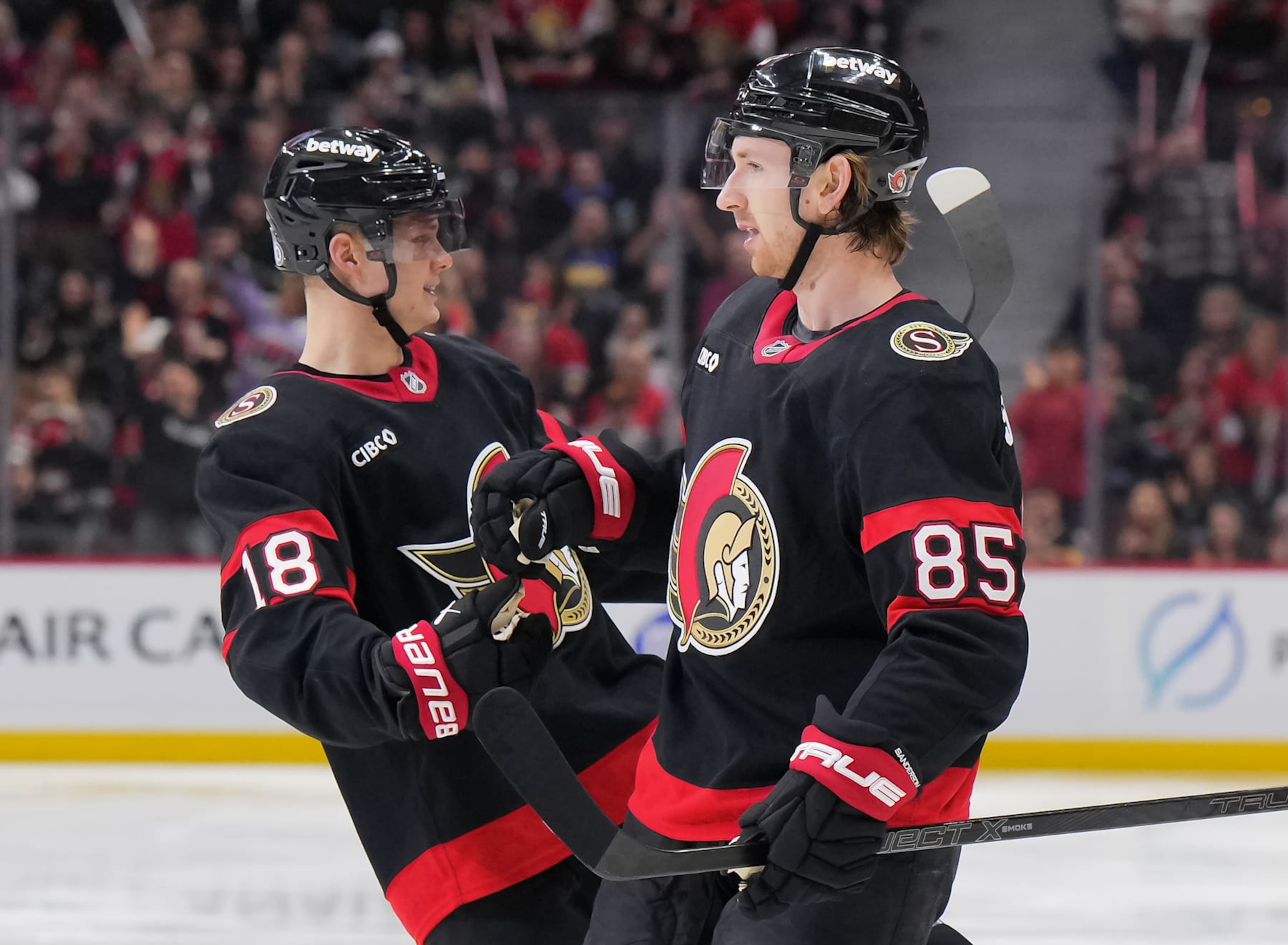 OTTAWA, CANADA - FEBRUARY 1: Jake Sanderson #85 of the Ottawa Senators celebrates his third period goal against the Minnesota Wild with teammate Tim Stützle #18 at Canadian Tire Centre on February 1, 2025 in Ottawa, Ontario, Canada.  (Photo by André Ringuette/NHLI via Getty Images)