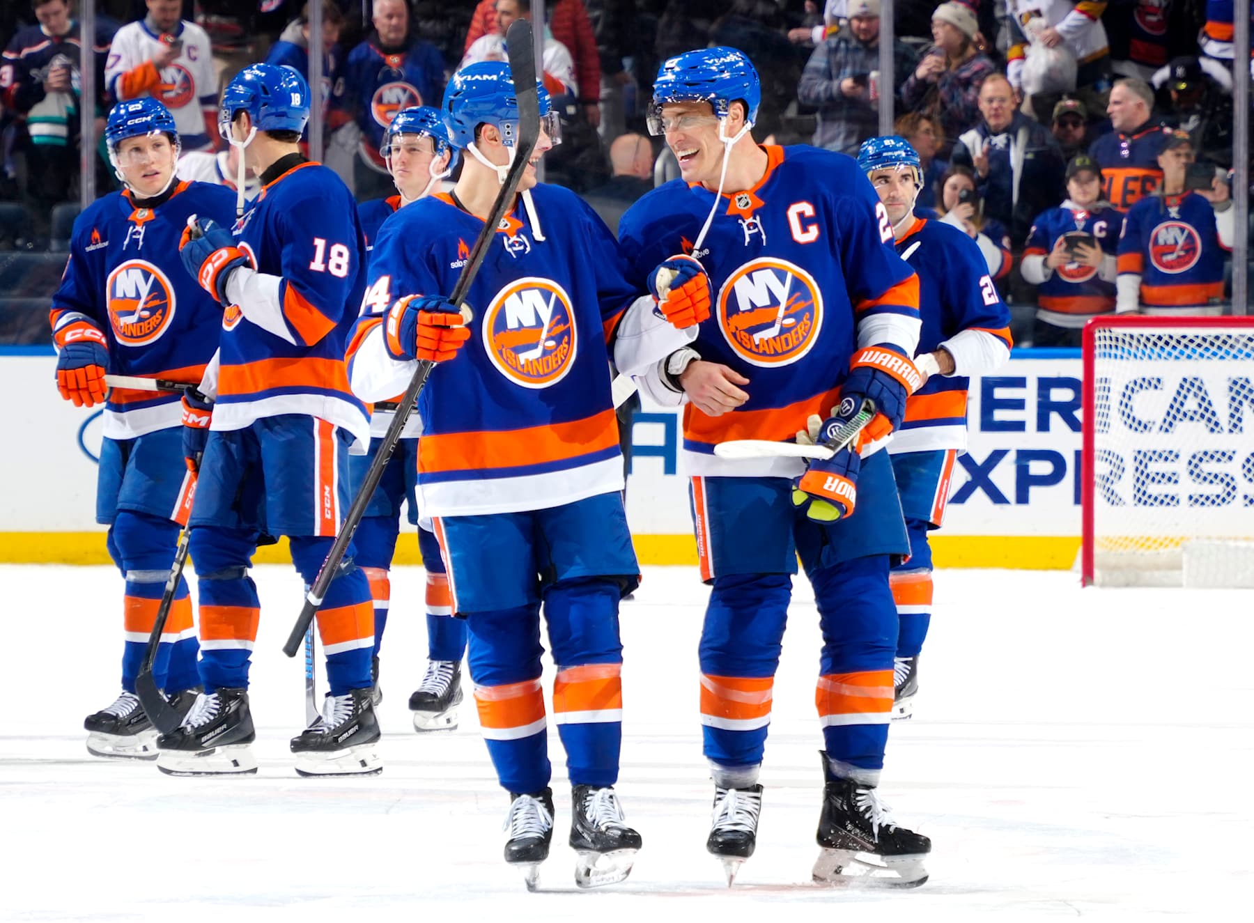 ELMONT, NEW YORK - FEBRUARY 04:  Adam Boqvist #34 and Anders Lee #27 of the New York Islanders celebrate the win against the Vegas Golden Knights at UBS Arena on February 04, 2025 in Elmont, New York. (Photo by Mike Stobe/NHLI via Getty Images)