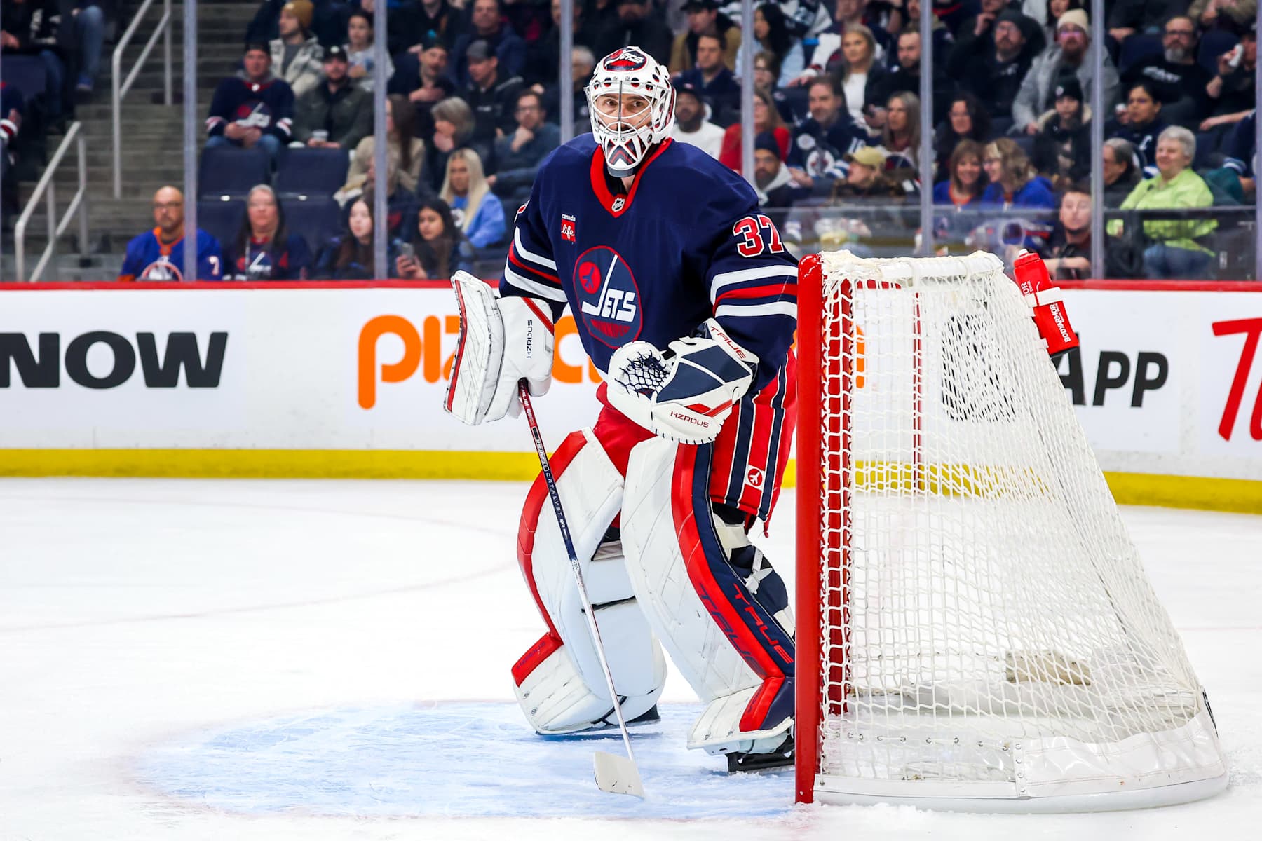 WINNIPEG, CANADA - FEBRUARY 7: Goaltender Connor Hellebuyck #37 of the Winnipeg Jets keeps an eye on the play during first period action against the New York Islanders at the Canada Life Centre on February 7, 2025 in Winnipeg, Manitoba, Canada. (Photo by Jonathan Kozub/NHLI via Getty Images)