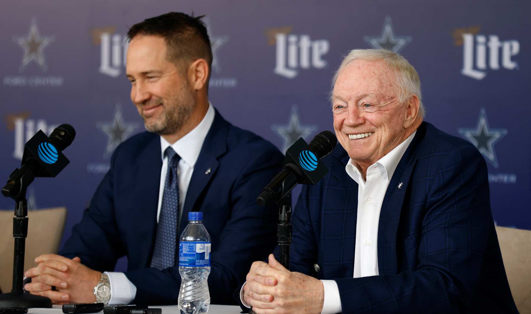 FRISCO, TEXAS - JANUARY 27:  New head coach of the Dallas Cowboys Brian Schottenheimer listens as team owner Jerry Jones talks during a press conference at The Star in Frisco on January 27, 2025 in Frisco, Texas. (Photo by Ron Jenkins/Getty Images)
