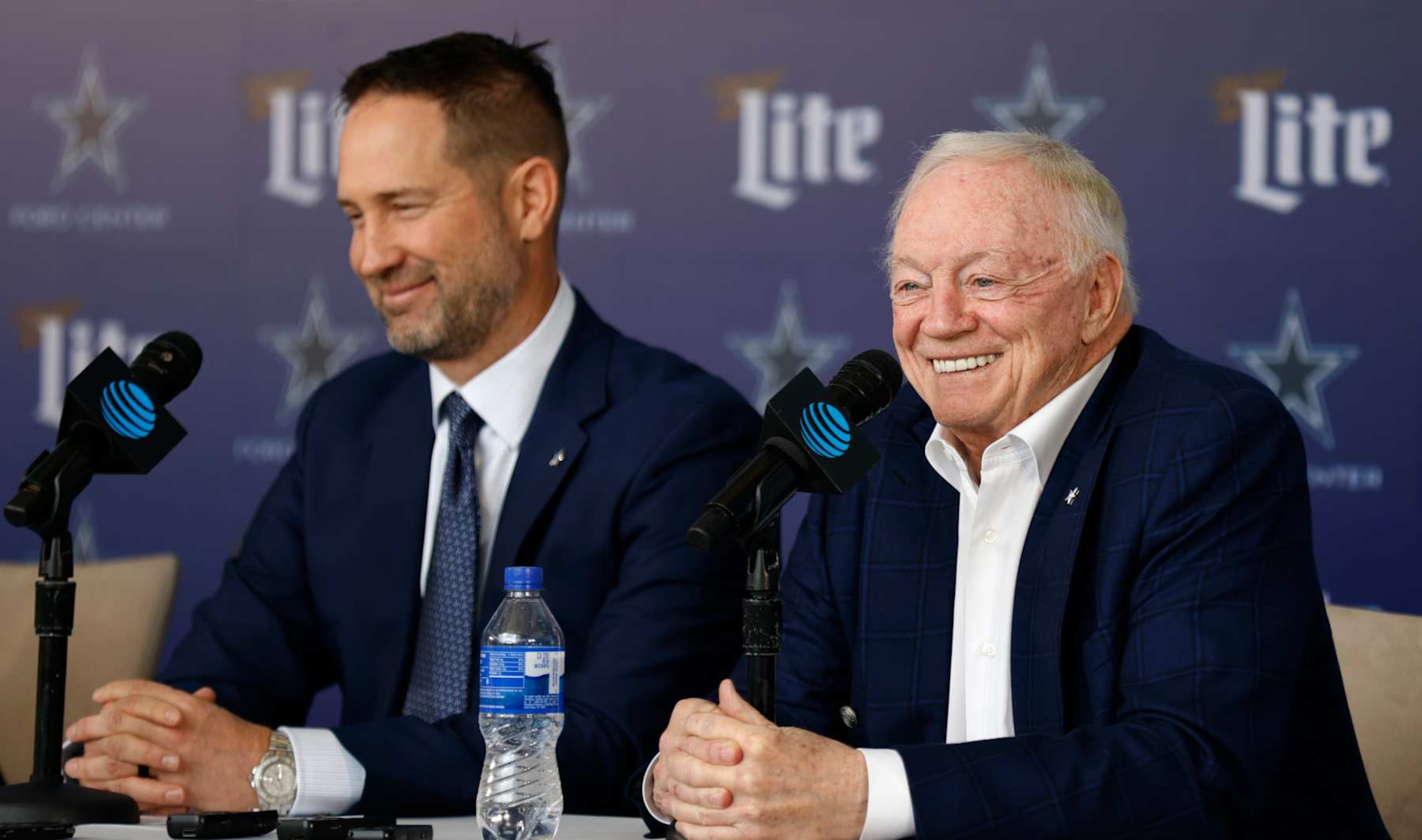 FRISCO, TEXAS - JANUARY 27:  New head coach of the Dallas Cowboys Brian Schottenheimer listens as team owner Jerry Jones talks during a press conference at The Star in Frisco on January 27, 2025 in Frisco, Texas. (Photo by Ron Jenkins/Getty Images)