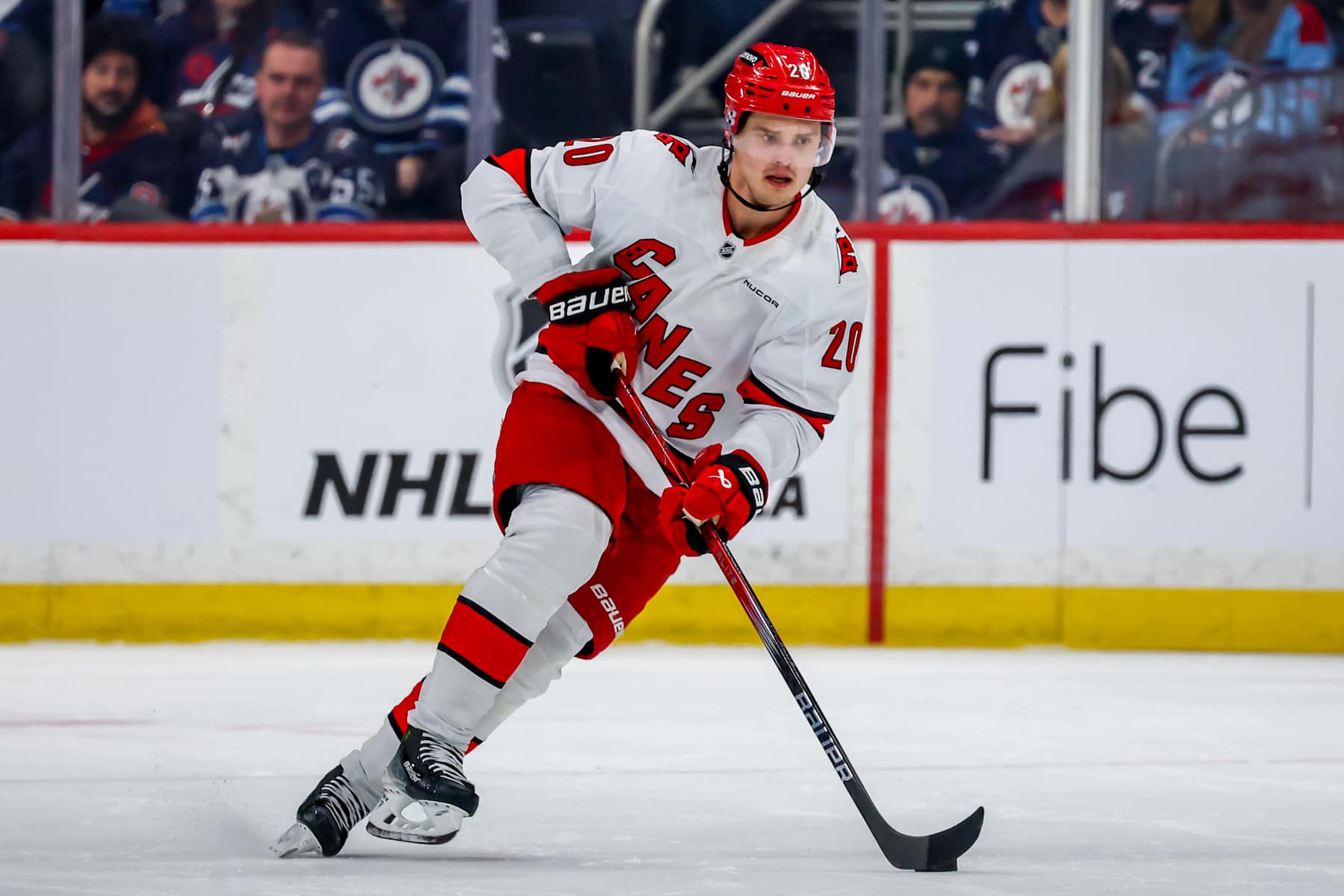 WINNIPEG, CANADA - FEBRUARY 04: Sebastian Aho #20 of the Carolina Hurricanes plays the puck during first period action against the Winnipeg Jets at Canada Life Centre on February 04, 2025 in Winnipeg, Manitoba, Canada. (Photo by Jonathan Kozub/NHLI via Getty Images)