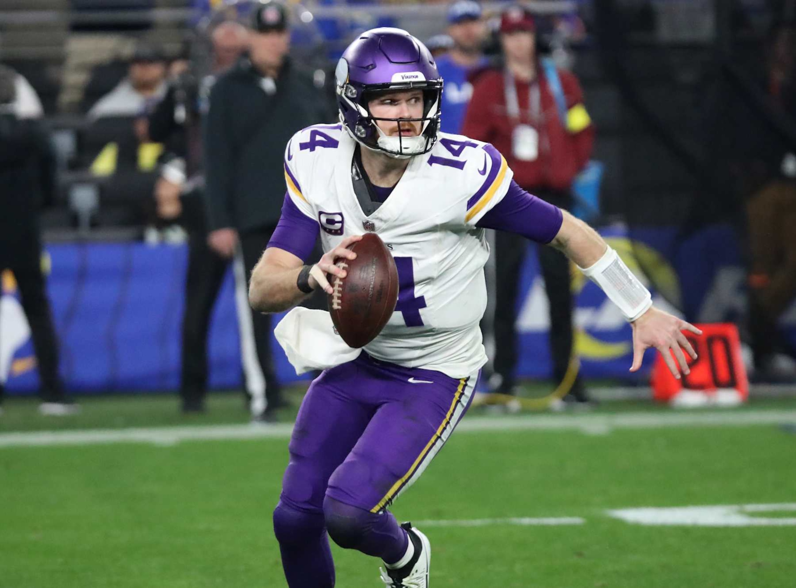 GLENDALE, ARIZONA - JANUARY 13: Quarterback Sam Darnold #14 of the Minnesota Vikings scrambles as he looks to throw a pass during the second half of the Minnesota Vikings versus Los Angeles Rams NFL Wild Card football game at State Farm Stadium on January 13, 2025 in Glendale, Arizona. (Photo by Bruce Yeung/Getty Images)