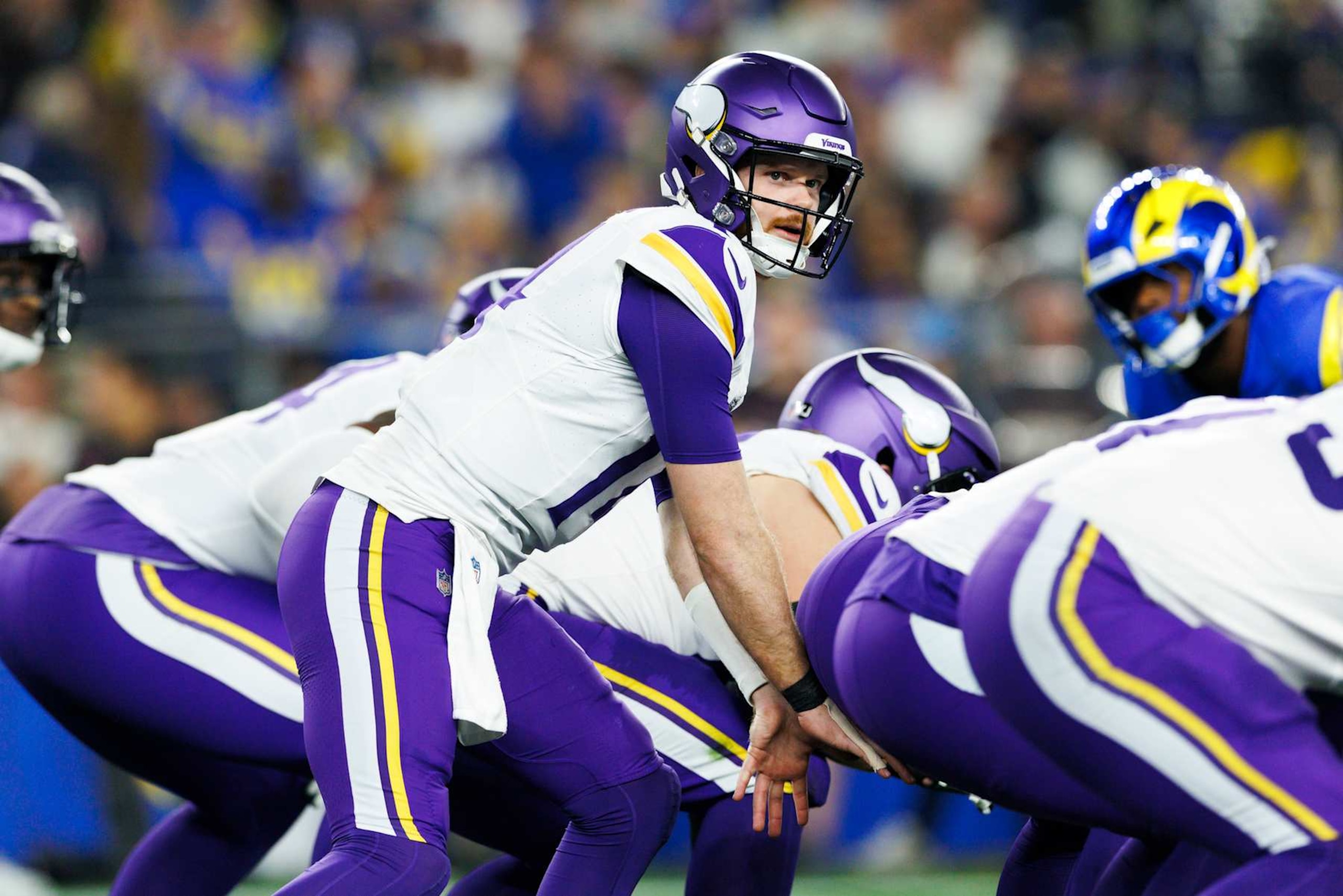 GLENDALE, ARIZONA - JANUARY 13: Sam Darnold #14 of the Minnesota Vikings under center during the first half of the NFC Wild Card Playoff game against the Los Angeles Rams at State Farm Stadium on January 13, 2025 in Glendale, Arizona. (Photo by Ric Tapia/Getty Images)