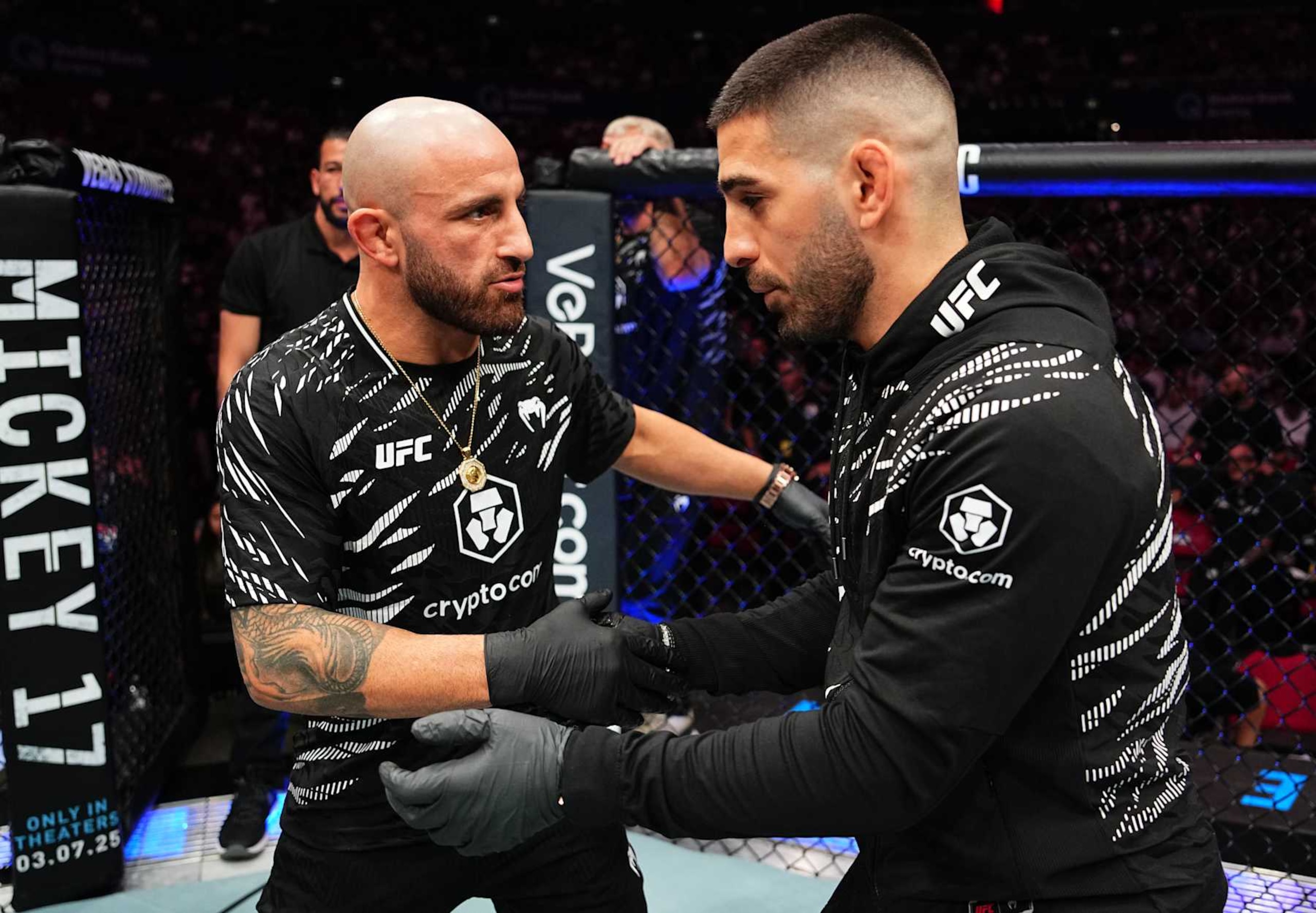 SYDNEY, AUSTRALIA - FEBRUARY 09: (L-R) Former opponents Alexander Volkanovski and Ilia Topuria talk after a bantamweight fight between Aleksandre Topuria and Colby Thicknesse during the UFC 312 event at Qudos Bank Arena on February 09, 2025 in Sydney, Australia. (Photo by Jeff Bottari/Zuffa LLC) SYDNEY, AUSTRALIA - FEBRUARY 09: (L-R) Former opponents Alexander Volkanovski and Ilia Topuria talk after a bantamweight fight between Aleksandre Topuria and Colby Thicknesse during the UFC 312 event at Qudos Bank Arena on February 09, 2025 in Sydney, Australia. (Photo by Jeff Bottari/Zuffa LLC)