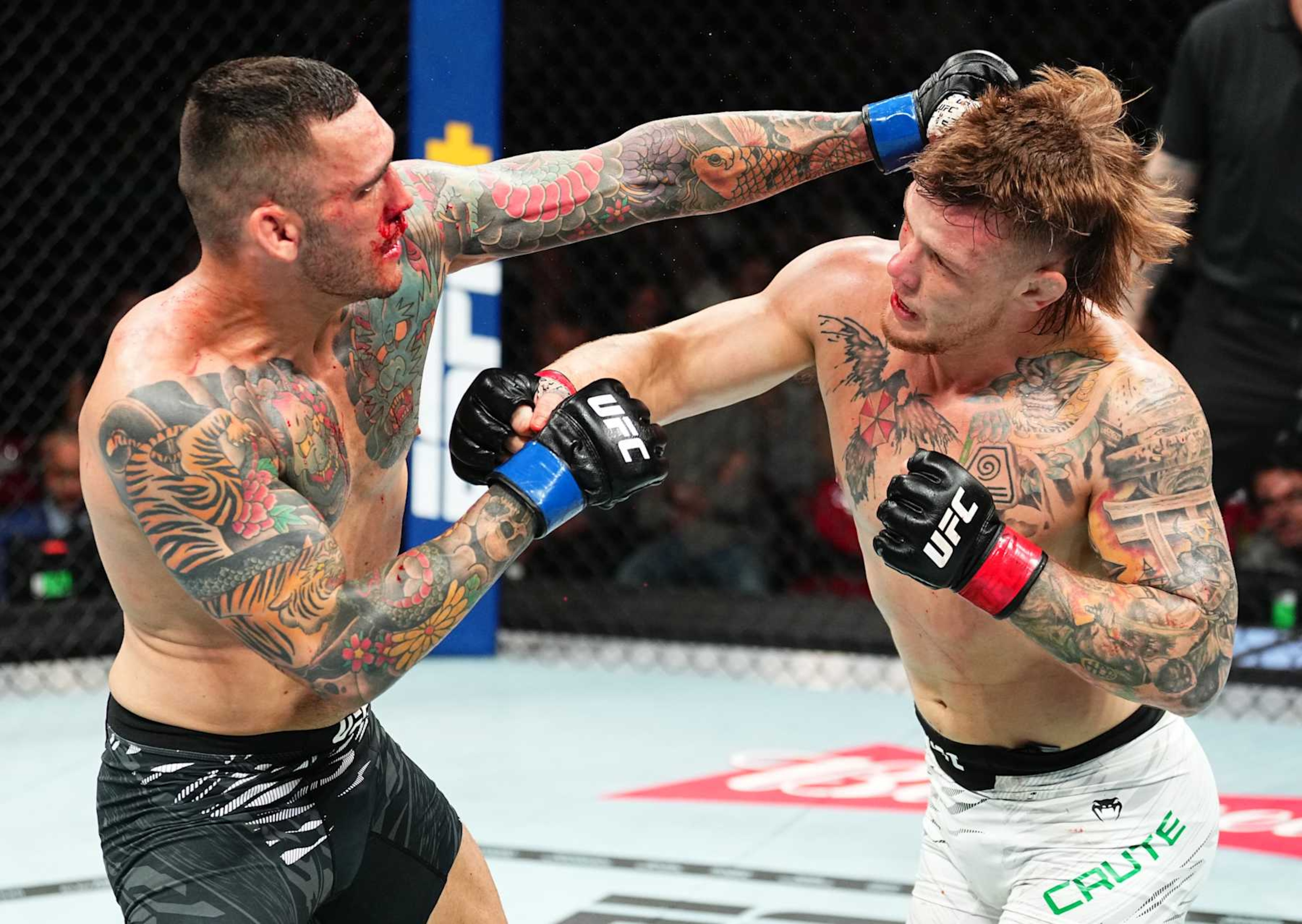 SYDNEY, AUSTRALIA - FEBRUARY 09: (L-R) Rodolfo Bellato of Brazil punches Jimmy Crute of Australia in a light heavyweight fight during the UFC 312 event at Qudos Bank Arena on February 09, 2025 in Sydney, Australia.  (Photo by Jeff Bottari/Zuffa LLC)