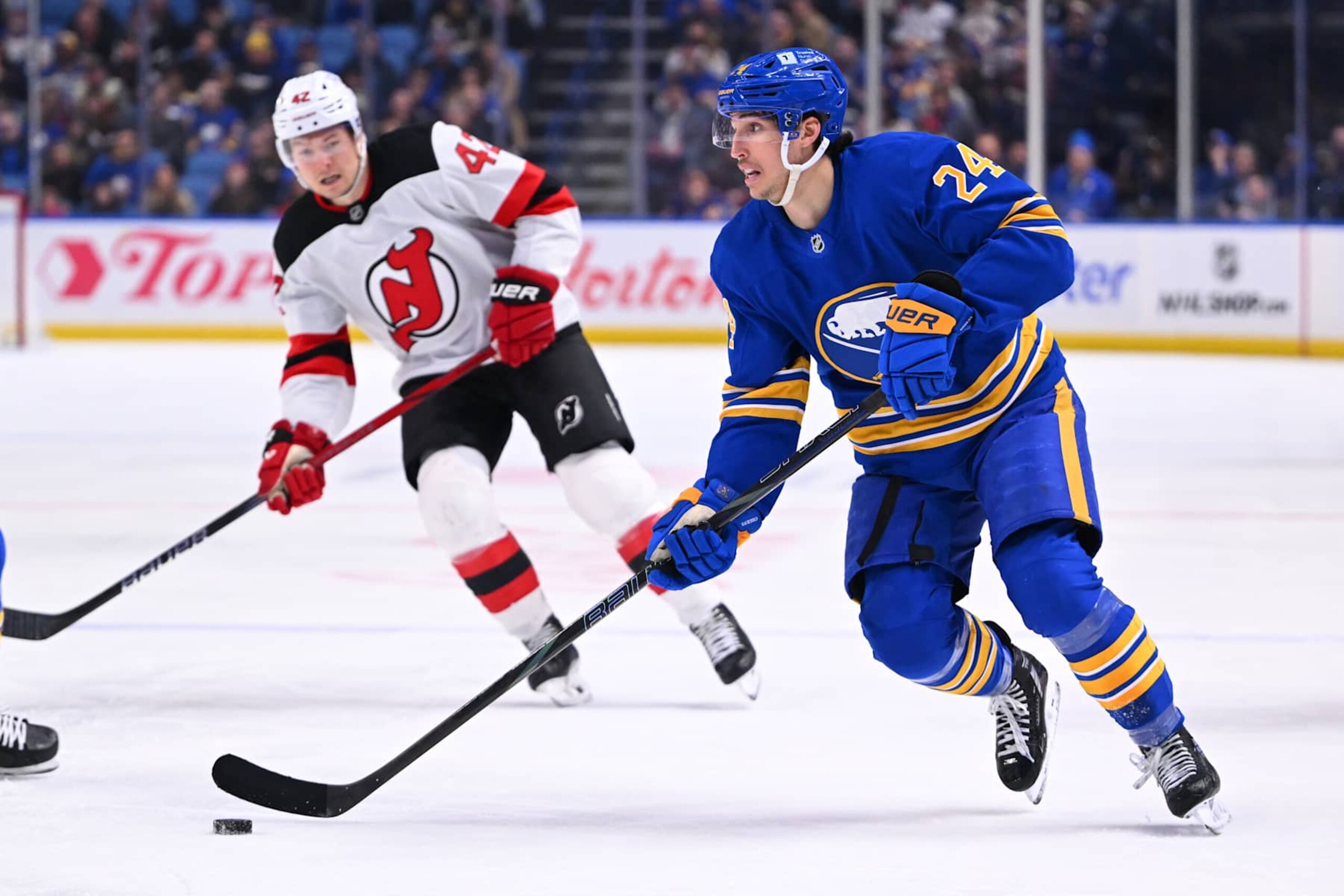 BUFFALO, NY - FEBRUARY 2: Dylan Cozens #24 of the Buffalo Sabres controls the puck against Curtis Lazar #42 of the New Jersey Devils during an NHL game on February 2, 2025 at KeyBank Center in Buffalo, New York. (Photo by Joe Hrycych/Getty Images)