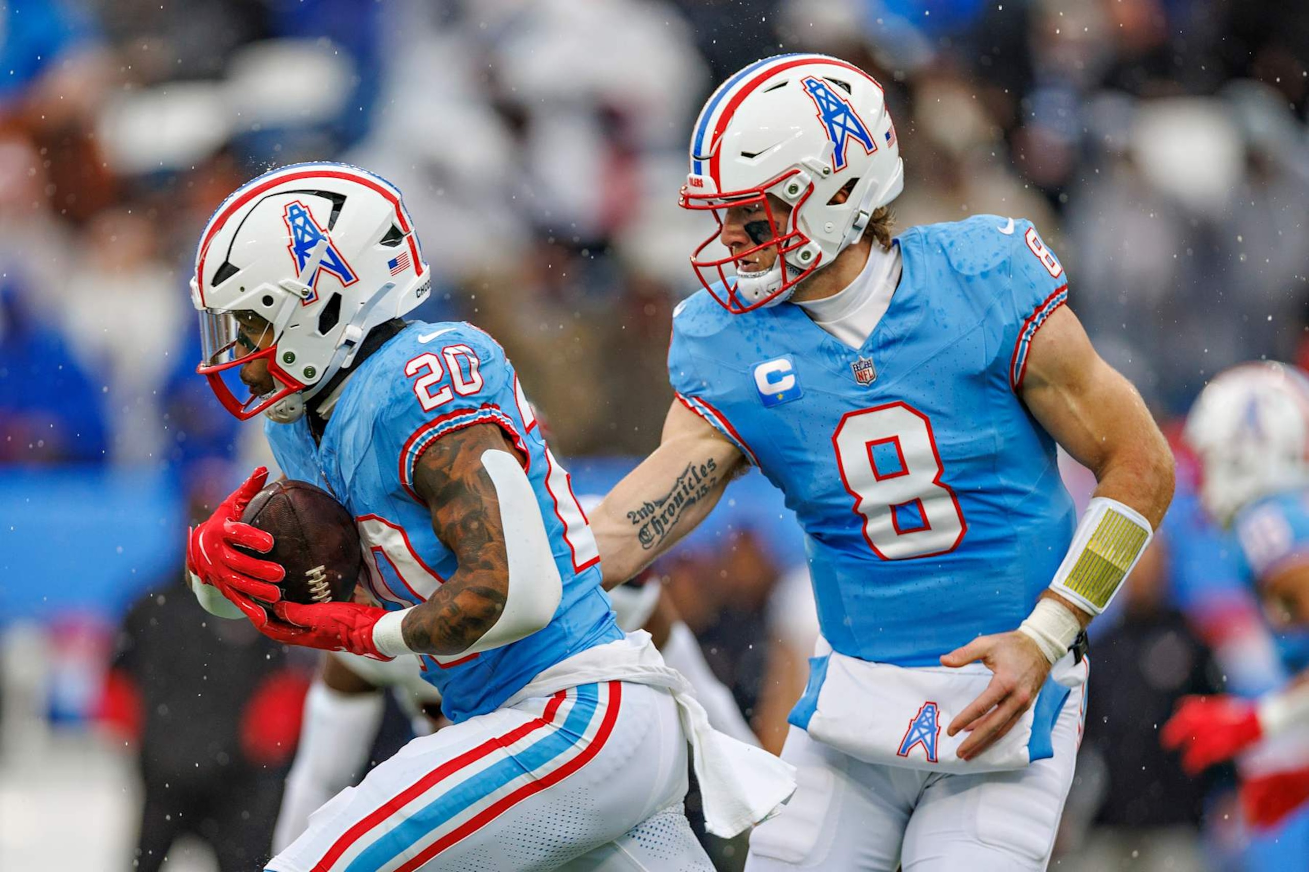 NASHVILLE, TENNESSEE - JANUARY 5: Will Levis #8 hands off the ball to Tony Pollard #20 of the Tennessee Titans during a game against the Houston Texans at Nissan Stadium on January 5, 2025 in Nashville, Tennessee. The Texans defeated the Titans 23-14.  (Photo by Wesley Hitt/Getty Images)