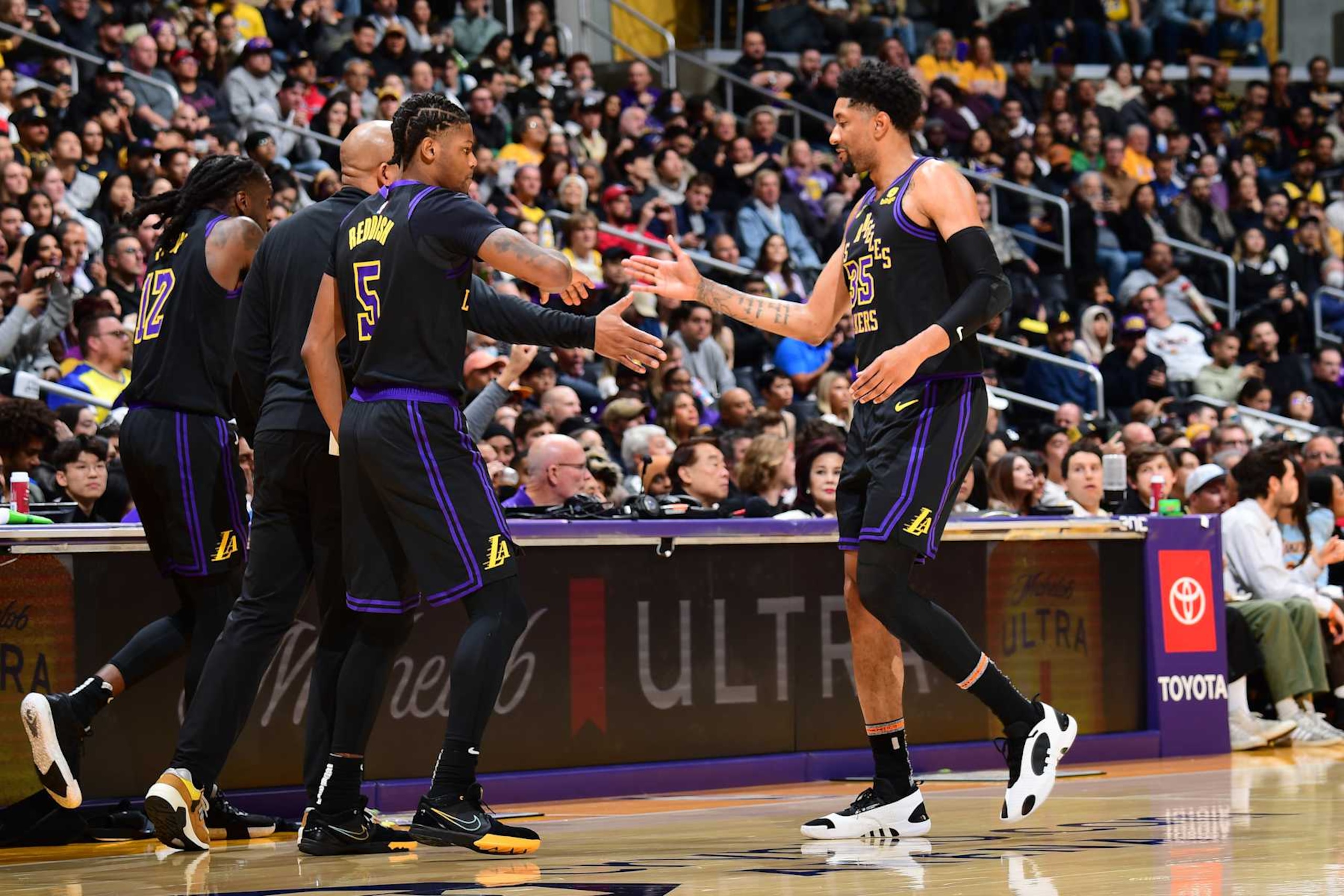 LOS ANGELES, CA - JANUARY 9: Cam Reddish #5 high fives Christian Wood #35 of the Los Angeles Lakers during the game against the Toronto Raptors on January 9, 2024 at Crypto.Com Arena in Los Angeles, California. NOTE TO USER: User expressly acknowledges and agrees that, by downloading and/or using this Photograph, user is consenting to the terms and conditions of the Getty Images License Agreement. Mandatory Copyright Notice: Copyright 2024 NBAE (Photo by Adam Pantozzi/NBAE via Getty Images)