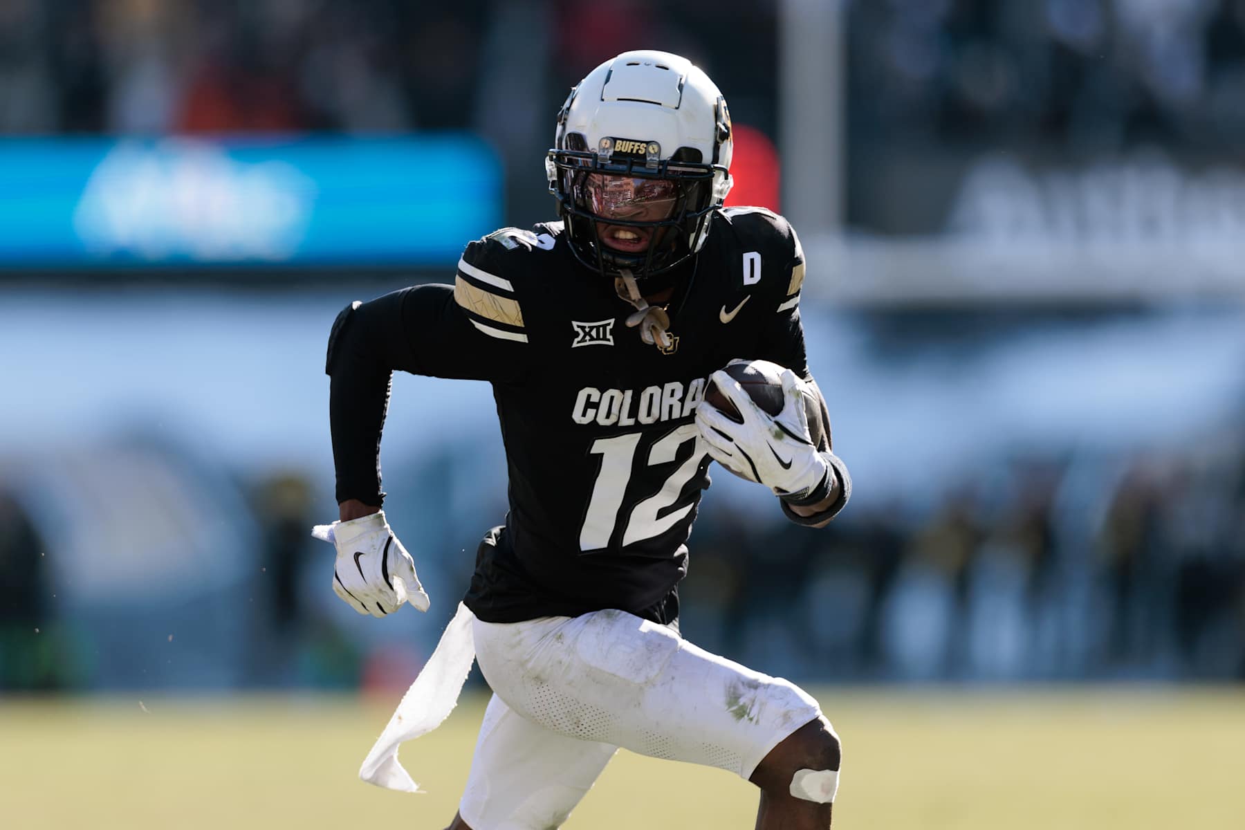 BOULDER, COLORADO - NOVEMBER 29: Travis Hunter #12 of the Colorado Buffaloes runs with the ball during the third quarter against the Oklahoma State Cowboys at Folsom Field on November 29, 2024 in Boulder, Colorado. (Photo by Andrew Wevers/Getty Images)