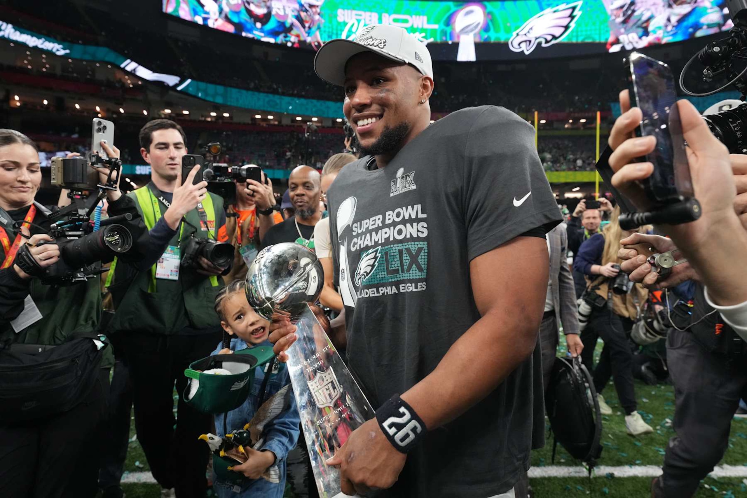Football: Super Bowl LIX: Philadelphia Eagles Saquon Barkley (26) in action, victorious with the Vince Lombardi trophy vs Kansas City Chiefs at Caesar's Superdome. 
New Orleans, LA 2/9/2025 
CREDIT: Erick W. Rasco (Photo by Erick W. Rasco/Sports Illustrated via Getty Images) 
(Set Number: X164676 TK1)