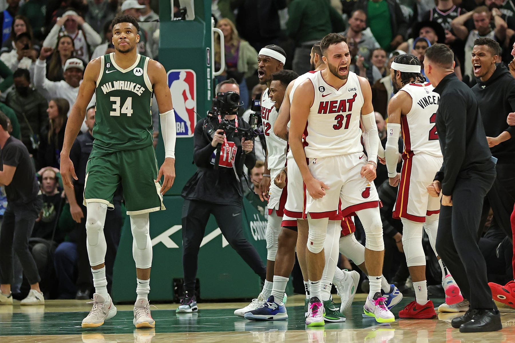 MILWAUKEE, WISCONSIN - APRIL 26: Max Strus #31 and members of the Miami Heat celebrate in front of Giannis Antetokounmpo #34 of the Milwaukee Bucks after winning Game 5 of the Eastern Conference First Round Playoffs in overtime at Fiserv Forum on April 26, 2023 in Milwaukee, Wisconsin. NOTE TO USER: User expressly acknowledges and agrees that, by downloading and or using this photograph, User is consenting to the terms and conditions of the Getty Images License Agreement. (Photo by Stacy Revere/Getty Images)