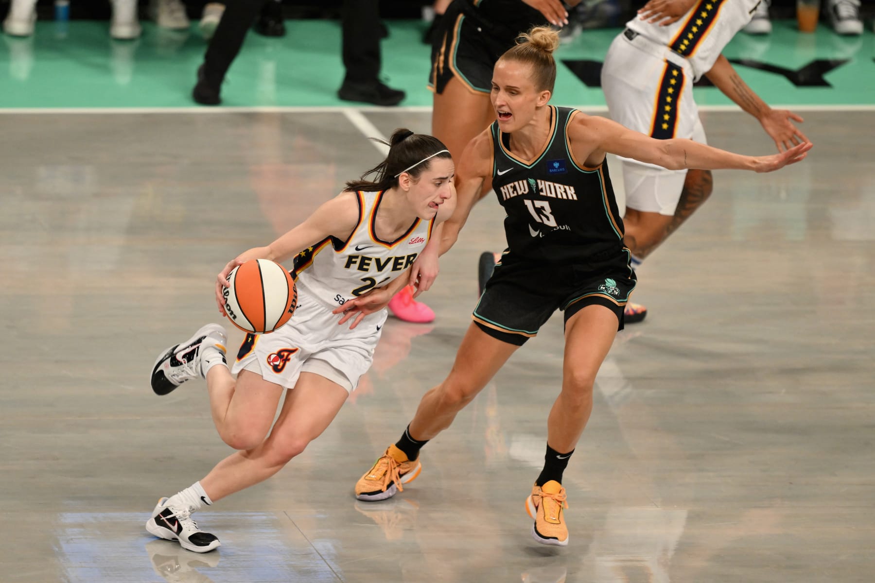 Indiana Fever #22 Caitlin Clark dribbles the ball while guarded by New York Liberty #13 Leonie Fiebich during a WNBA game between the Fever and Liberty, at the Barclays Center in Brooklyn on May 18, 2024, in New York City. (Photo by ANGELA WEISS / AFP) (Photo by ANGELA WEISS/AFP via Getty Images)