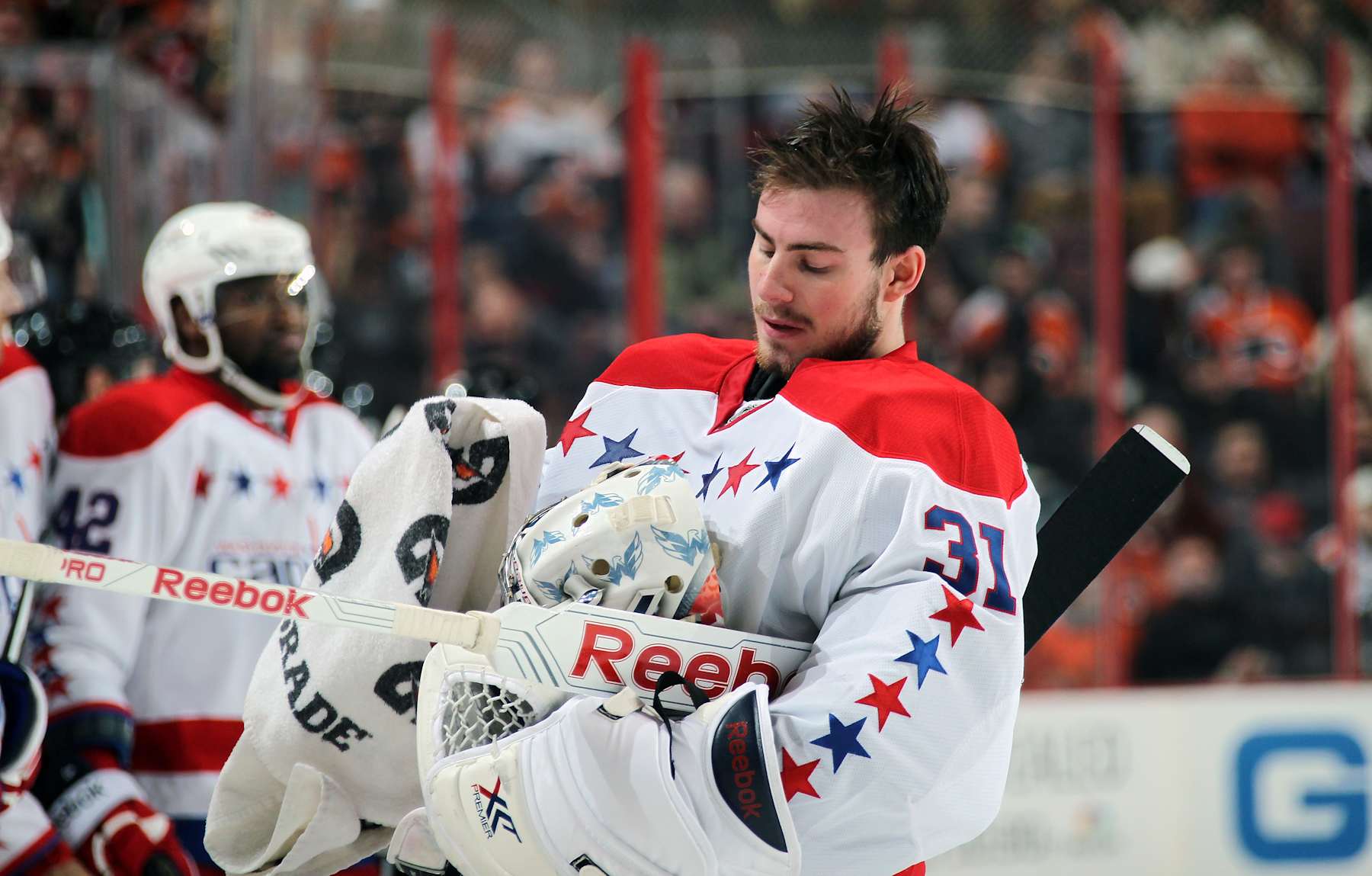PHILADELPHIA, PA - MARCH 05:  Philipp Grubauer #31 of the Washington Capitals wipes off his goaltending mask during a stoppage in play against the Philadelphia Flyers on March 5, 2014 at the Wells Fargo Center in Philadelphia, Pennsylvania.  (Photo by Len Redkoles/NHLI via Getty Images) 