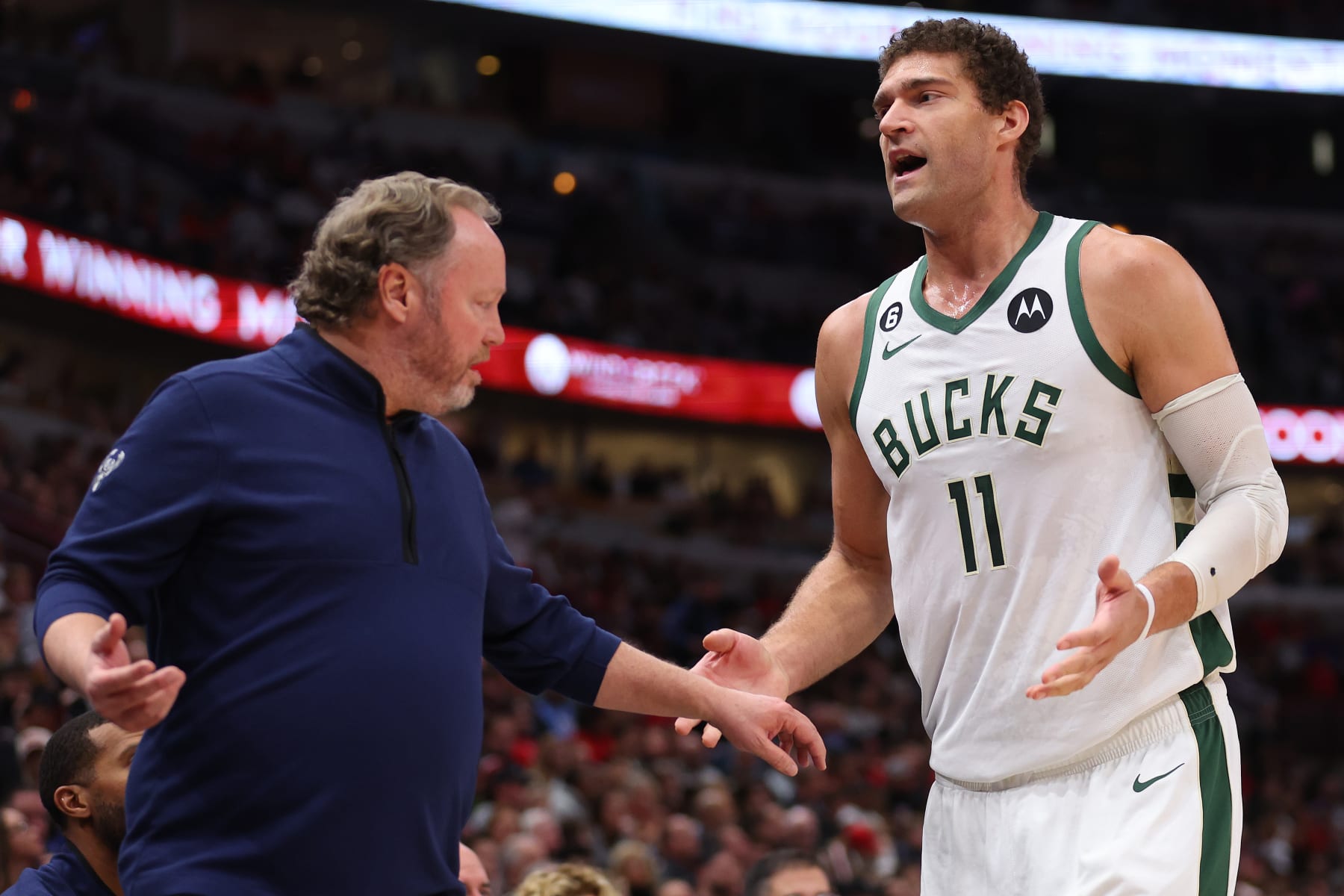 CHICAGO, ILLINOIS - DECEMBER 28: Head coach Mike Budenholzer of the Milwaukee Bucks talks with Brook Lopez #11 against the Chicago Bulls during the first half at United Center on December 28, 2022 in Chicago, Illinois. NOTE TO USER: User expressly acknowledges and agrees that, by downloading and or using this photograph, User is consenting to the terms and conditions of the Getty Images License Agreement. (Photo by Michael Reaves/Getty Images)