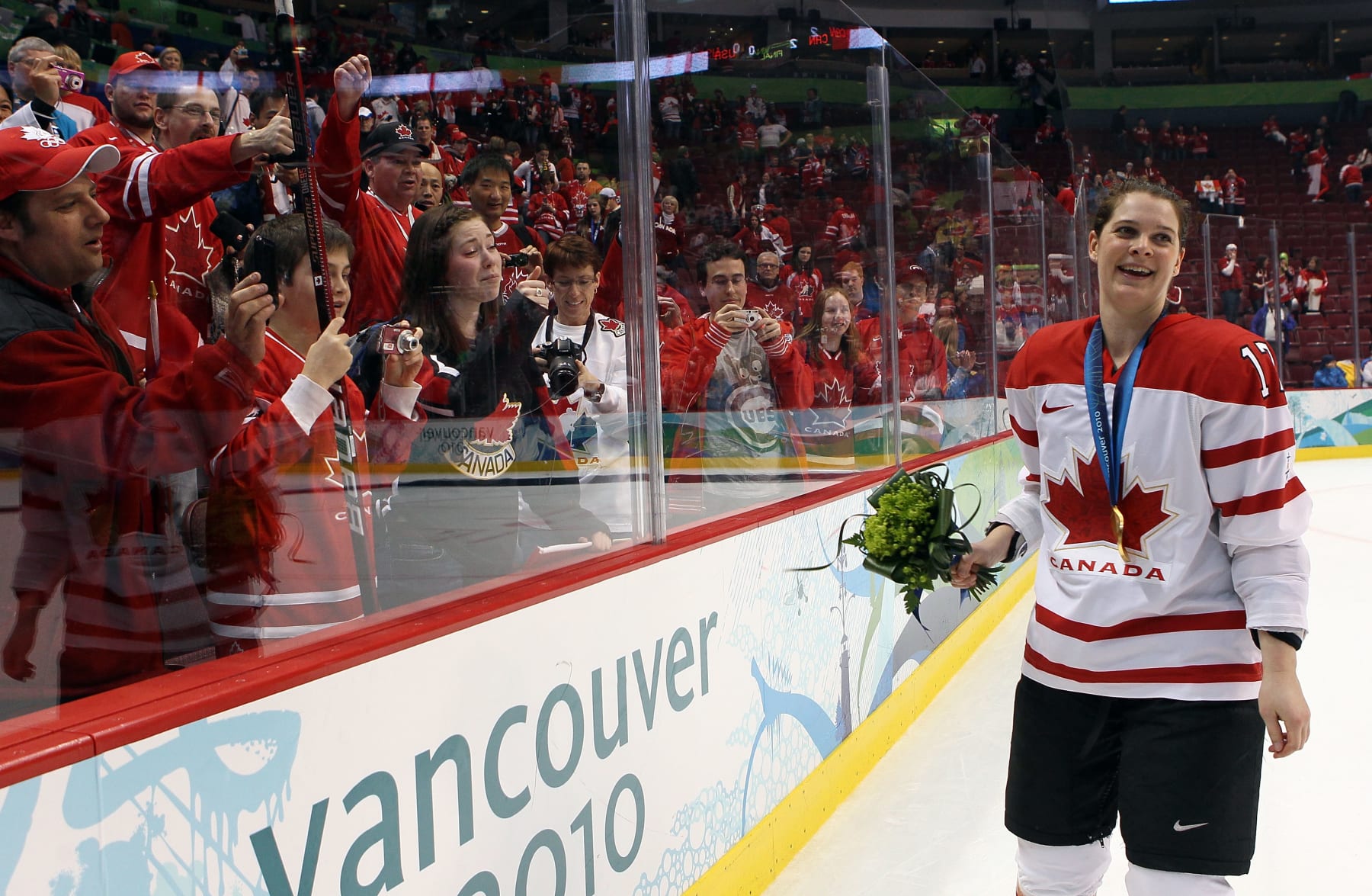 VANCOUVER, BC - FEBRUARY 25:  Jennifer Botterill #17 of Canada celebrates with the fans after winning the gold medal during the ice hockey women's gold medal game between Canada and USA on day 14 of the Vancouver 2010 Winter Olympics at Canada Hockey Place on February 25, 2010 in Vancouver, Canada.  (Photo by Bruce Bennett/Getty Images)