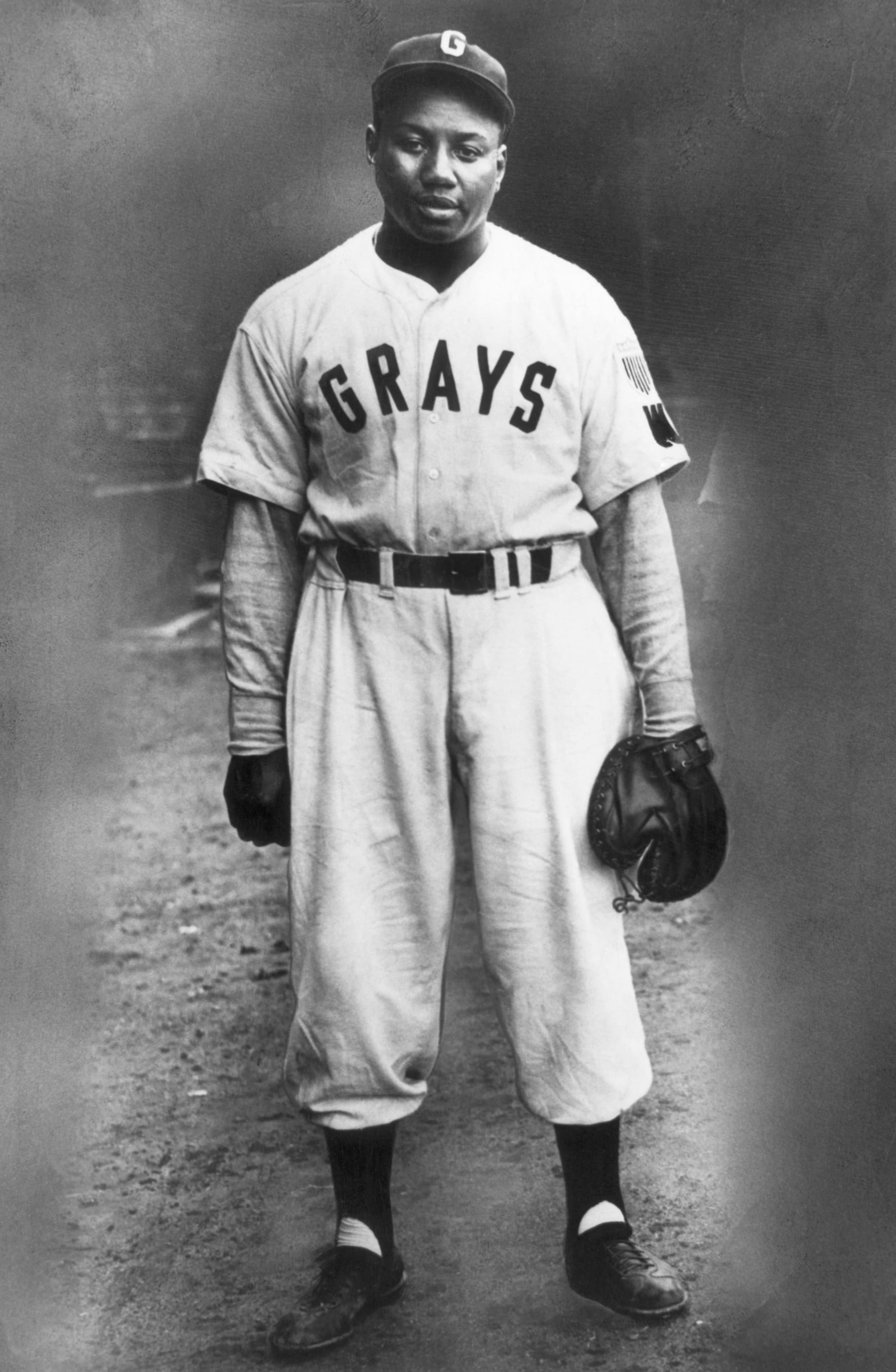 Portrait of baseball great Josh Gibson in a Homestead Grays baseball uniform. Known as the "Black Babe Ruth" for his home run prowess, Gibson played for the Pittsburgh Crawfords and the Homestead Grays in the Negro Leagues. He never had the opportunity to play in the Major Leagues because he died a few months before Jackie Robinson's historic debut with the Brooklyn Dodgers. 1945.