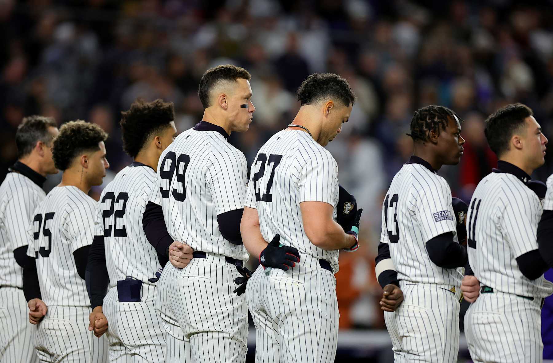 NEW YORK, NEW YORK - OCTOBER 28: Aaron Judge #99 and Giancarlo Stanton #27 of the New York Yankees look on during the national anthem prior to playing the Los Angeles Dodgers during Game Three of the 2024 World Series at Yankee Stadium on October 28, 2024 in the Bronx borough of New York City. (Photo by Alex Slitz/Getty Images)