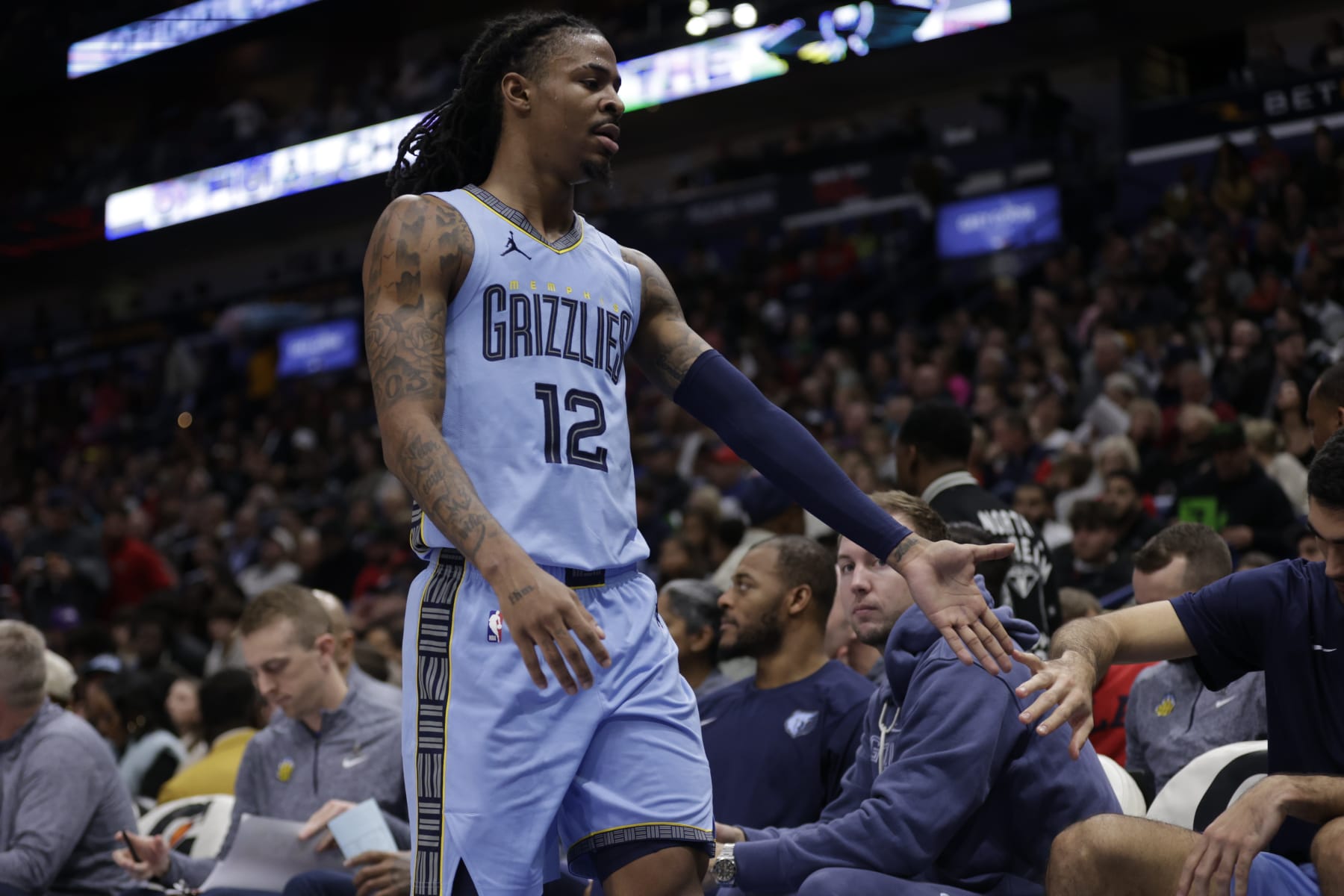 NEW ORLEANS, LA - DECEMBER 26: Ja Morant #12 of the Memphis Grizzlies walks towards the bench during the game against the New Orleans Pelicans on December 26, 2023 at the Smoothie King Center in New Orleans, Louisiana. NOTE TO USER: User expressly acknowledges and agrees that, by downloading and or using this Photograph, user is consenting to the terms and conditions of the Getty Images License Agreement. Mandatory Copyright Notice: Copyright 2023 NBAE (Photo by Derick Hingle/NBAE via Getty Images)