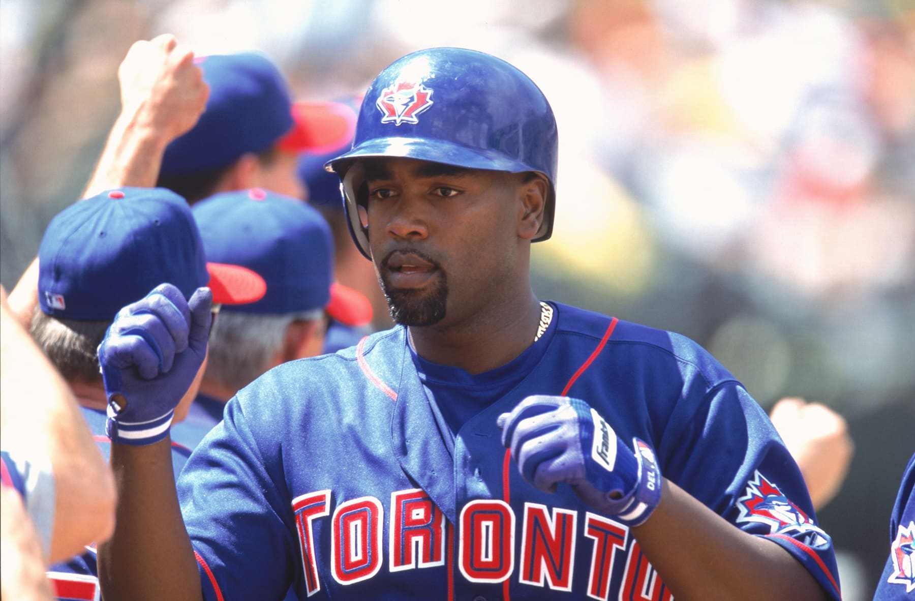 OAKLAND, CA - 2002:  Carlos Delgado of the Toronto Blue Jays celebrates with his teammates during a 2002 season game at Network Associates Coliseum in Oakland, California . (Photo by Brad Mangin/MLB Photos via Getty Images)