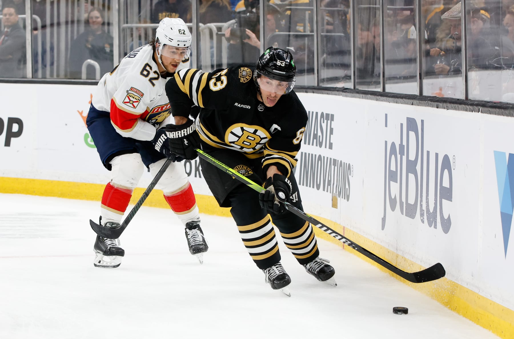BOSTON, MASSACHUSETTS - APRIL 6: Brad Marchand #63 of the Boston Bruins controls the puck away from Brandon Montour #62 of the Florida Panthers during the third period at the TD Garden on April 6, 2024 in Boston, Massachusetts. The Bruins won 3-2 in overtime. (Photo by Richard T Gagnon/Getty Images)
