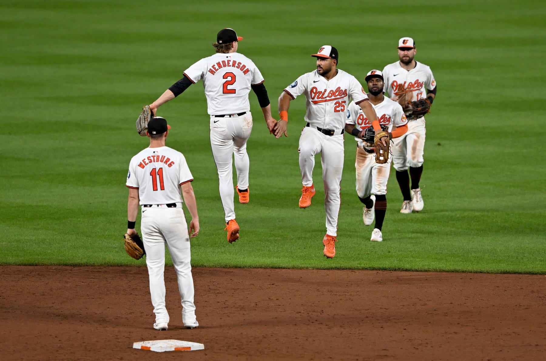 BALTIMORE, MARYLAND - JULY 30: Gunnar Henderson #2 and Anthony Santander #25 of the Baltimore Orioles celebrate a 6-2 victory against the Toronto Blue Jays at Oriole Park at Camden Yards on July 30, 2024 in Baltimore, Maryland. (Photo by Greg Fiume/Getty Images)