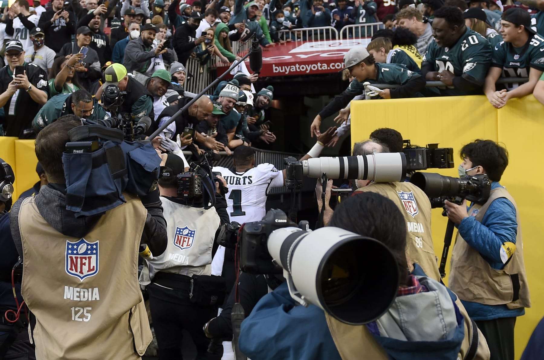 LANDOVER, MARYLAND - JANUARY 02:  A railing collapses as Jalen Hurts #1 of the Philadelphia Eagles walks through the tunnel celebrating with eagles fans following the win over the Washington Football Team 20-16 at FedExField on January 02, 2022 in Landover, Maryland.