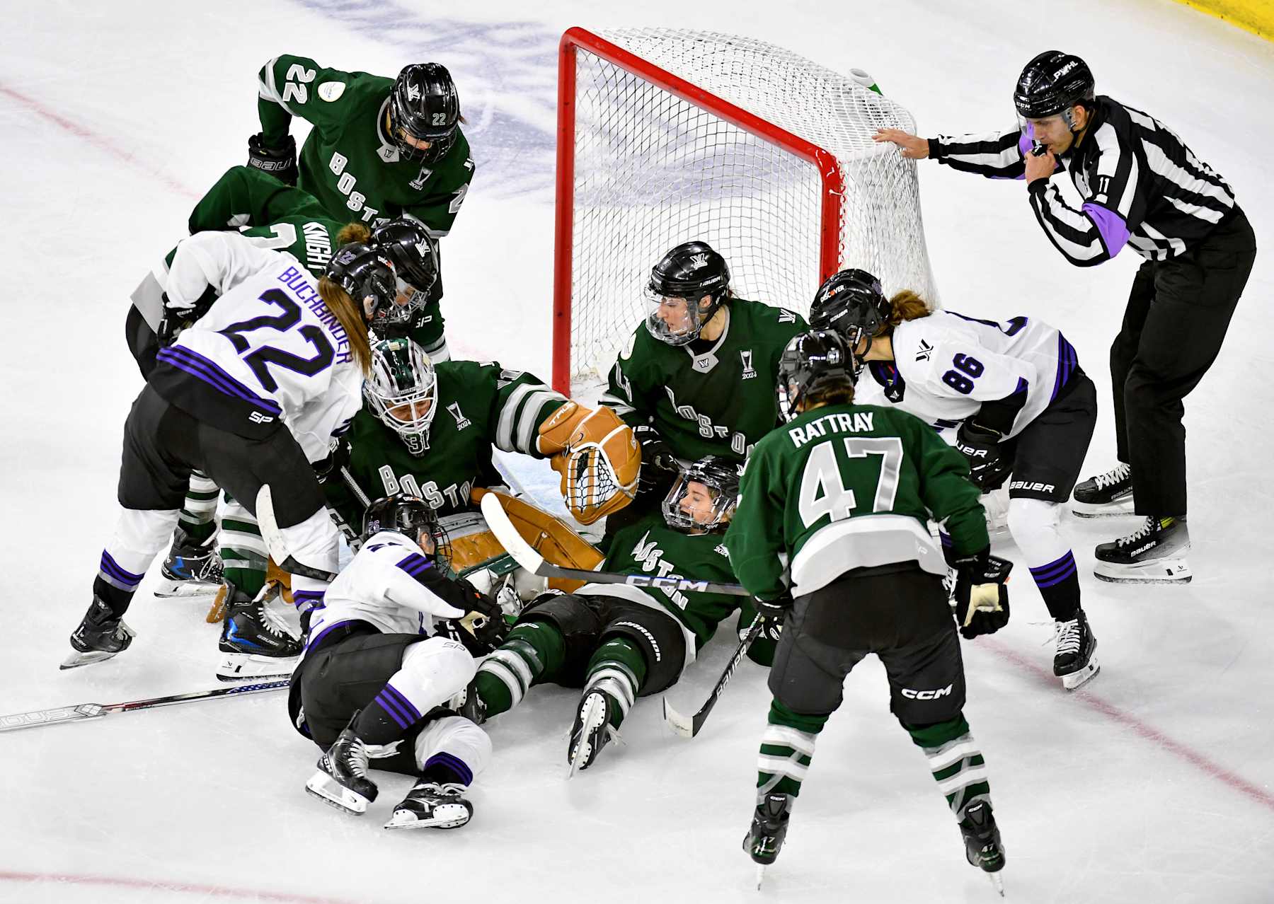 LOWELL, MASSACHUSETTS - MAY 29: Referee David Elford blows the whistle as he loses sight of the puck somewhere under  Kaleigh Fratkin #13,  Hannah Brandt #20,  Aerin Frankel #31 of Boston in the crease during scrum in the second period  at Tsongas Center on May 29, 2024 in Lowell, Massachusetts. (Photo by Troy Parla/Getty Images)
