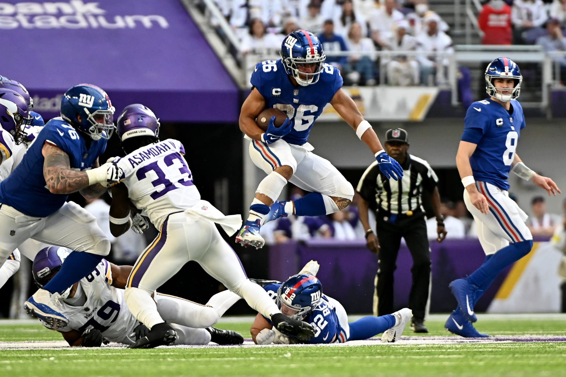 MINNEAPOLIS, MINNESOTA - DECEMBER 24: Saquon Barkley #26 of the New York Giants hurdles a player during the second quarter against the Minnesota Vikings at U.S. Bank Stadium on December 24, 2022 in Minneapolis, Minnesota. The play was called back due to a penalty. (Photo by Stephen Maturen/Getty Images)