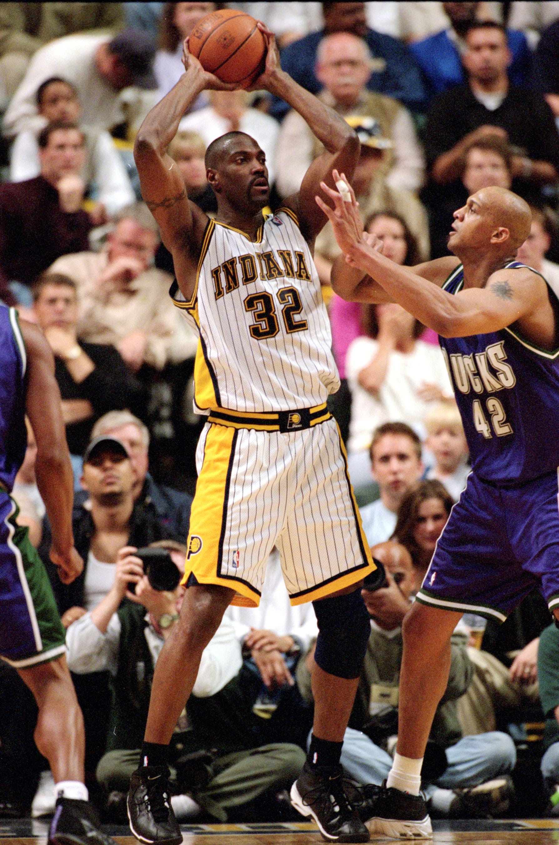 23 Apr 2000: Dale Davis #32 of the Indiana Pacers looks to pass the ball as he is blocked by Scott Williams #42 of the Milwaukee Bucks during the NBA Eastern Conference Playoffs Round One Game at the Conseco Fieldhouse in Indianapolis, Indiana. The Pacers defeated the Bucks 88-85..   Mandatory Credit: Jonathan Daniel  /Allsport