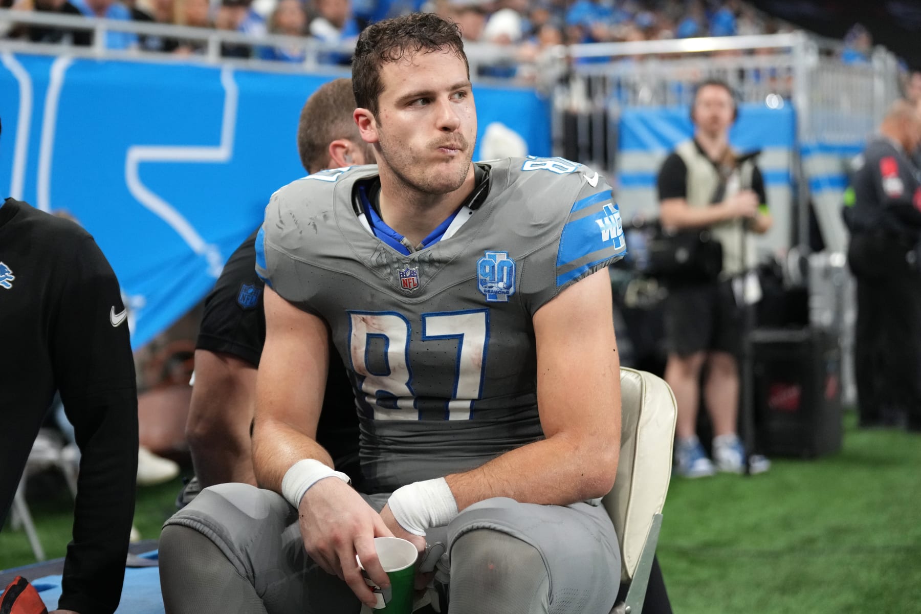 DETROIT, MICHIGAN - JANUARY 07: Sam LaPorta #87 of the Detroit Lions is taken off the field during the first half in the game against the Minnesota Vikings at Ford Field on January 07, 2024 in Detroit, Michigan. (Photo by Nic Antaya/Getty Images)