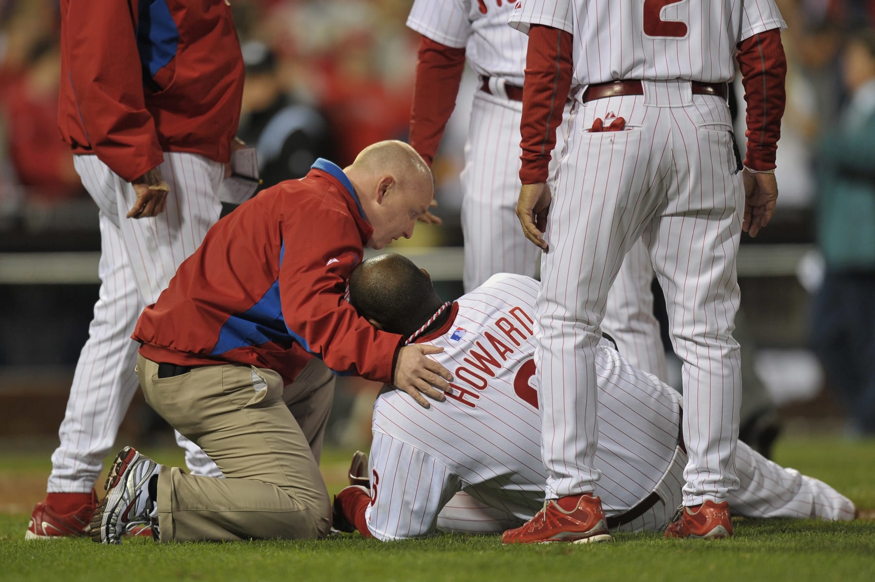 PHILADELPHIA, PA - OCTOBER 07:  Ryan Howard #6 of the Philadelphia Phillies is tended to after he was hurt on the last play of the game as the Phillies lost 1-0 against the St. Louis Cardinals during Game Five of the National League Divisional Series at Citizens Bank Park on October 7, 2011 in Philadelphia, Pennsylvania.  (Photo by Drew Hallowell/Getty Images)
