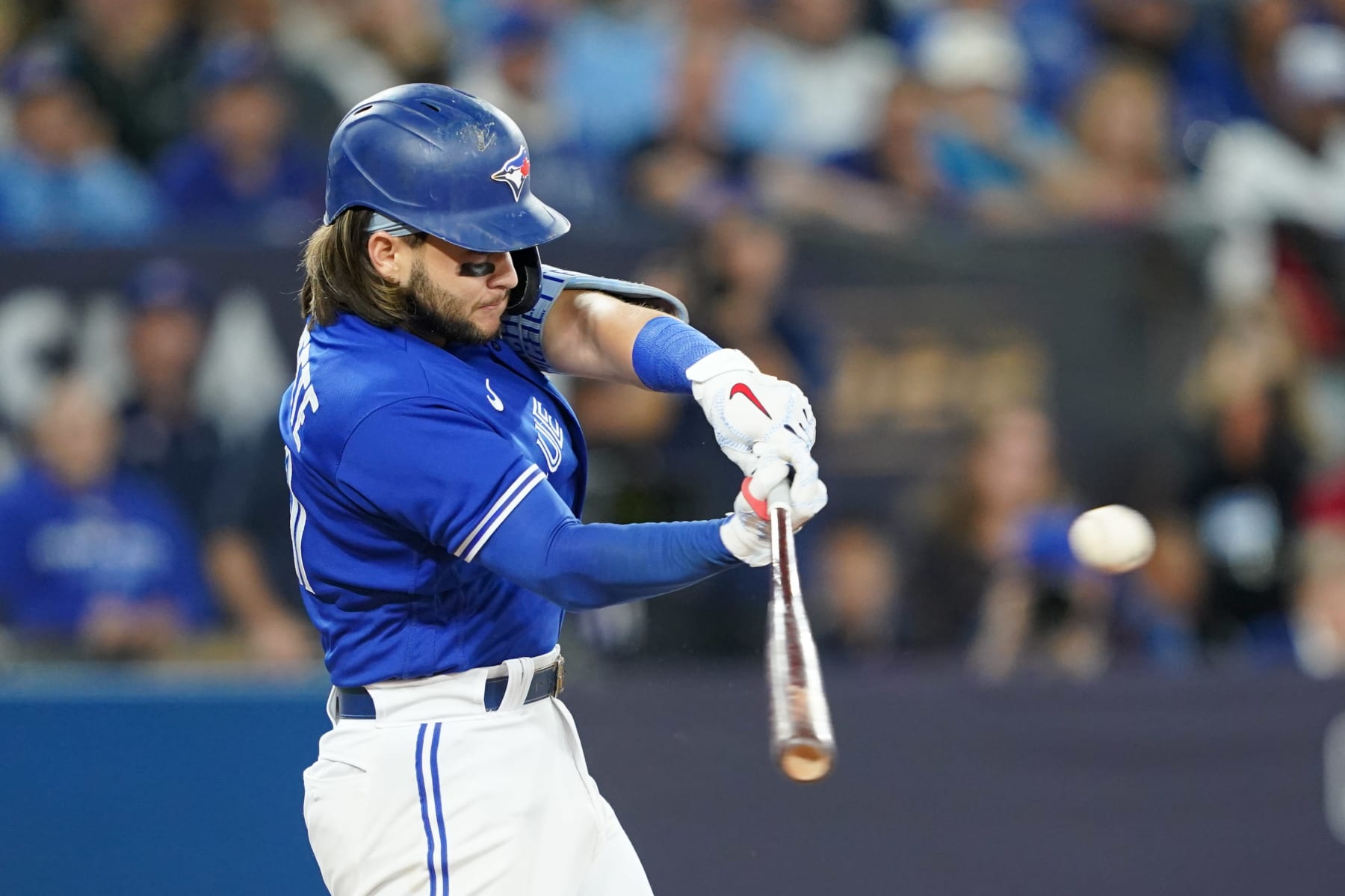 TORONTO,  - OCTOBER 08:   Bo Bichette #11 of the Toronto Blue Jays doubles in the fifth inning during the Wild Card Series game between the Seattle Mariners and the Toronto Blue Jays at Rogers Centre on Saturday, October 8, 2022 in Toronto, Canada. (Photo by Thomas Skrlj/MLB Photos via Getty Images)