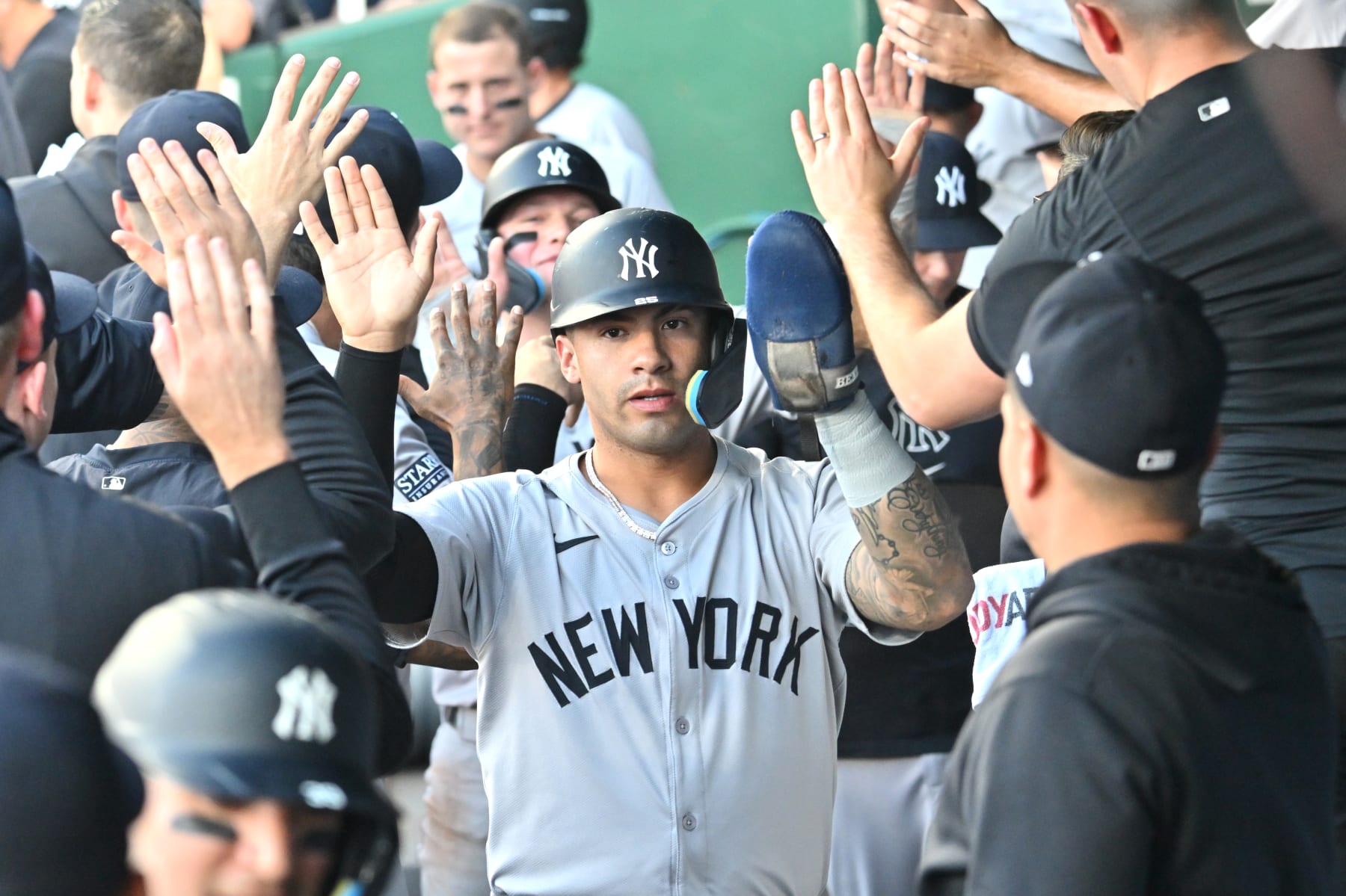 KANSAS CITY, MO - JUNE 12: New York Yankees second baseman Gleyber Torres (25) is congratulated by teammates after scoring during the New York Yankees at Kansas City Royals MLB game on June 12, 2024, at Kauffman Stadium, Kansas City, MO.  (Photo by Keith Gillett/Icon Sportswire via Getty Images)