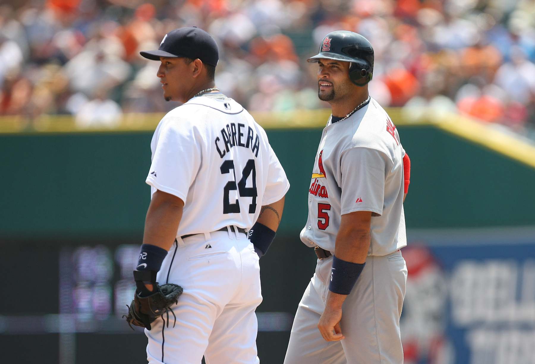 DETROIT, MI - JUNE 26: Albert Pujols #5 of the St. Louis Cardinals looks on from first base as Miguel Cabrera #24 of the Detroit Tigers holds him on during their MLB game on June 26, 2008 in Detroit, Michigan. (Photo by Tom Szczerbowski/Getty Images)
