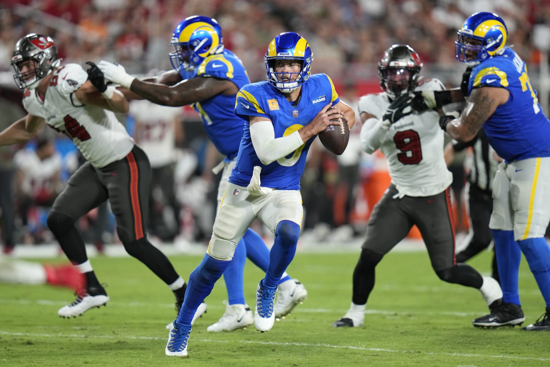 Los Angeles Rams quarterback Matthew Stafford (9) scrambles against the Tampa Bay Buccaneers during the second half of an NFL football game Wednesday, Nov. 9, 2022, in Tampa, Fla. (AP Photo/Chris O'Meara)