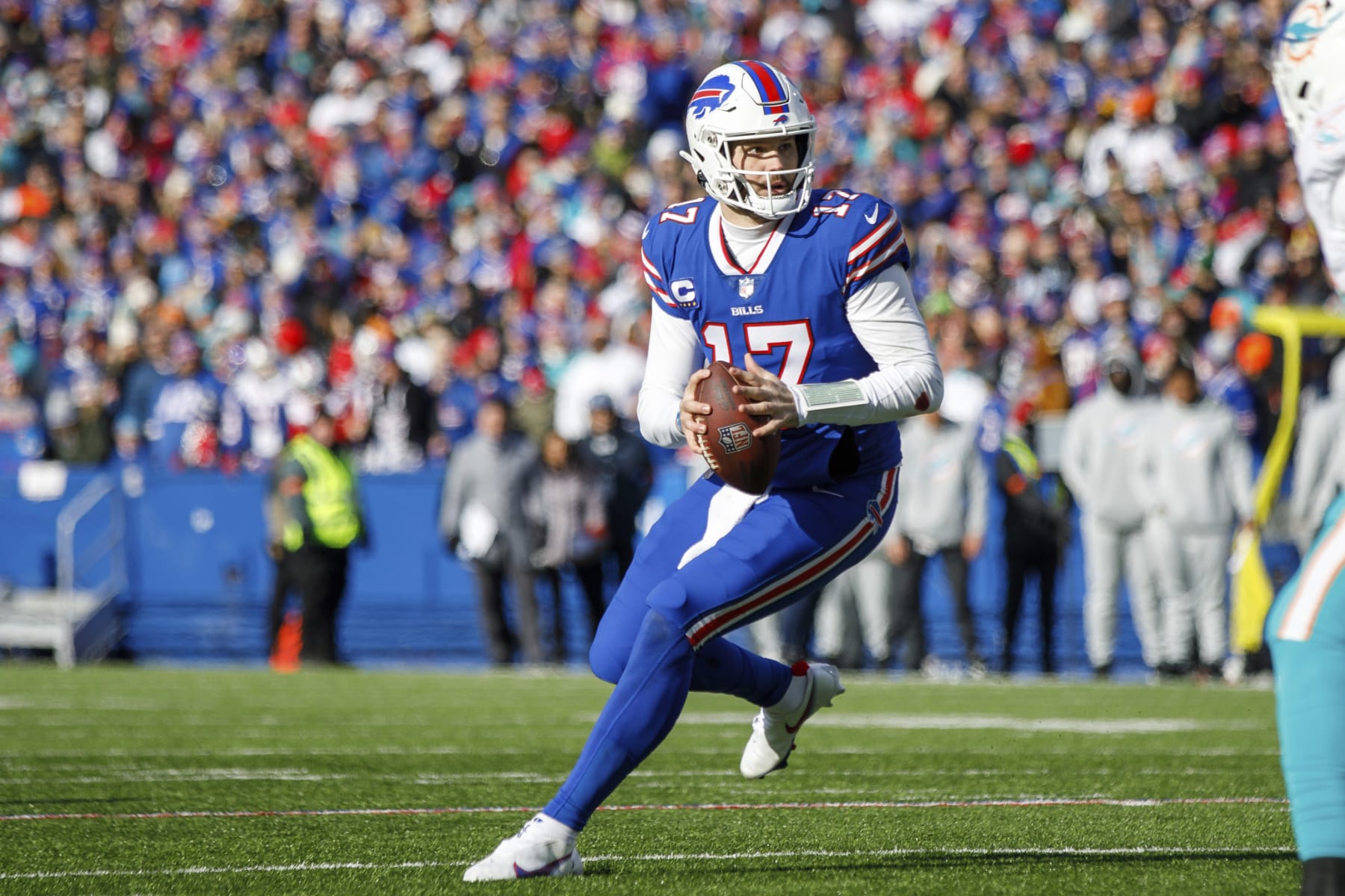 Buffalo Bills quarterback Josh Allen (17) rolls out before throwing a touchdown pass against the Miami Dolphins during an NFL wild-card football game Sunday, Jan. 15, 2023, in Orchard Park, NY. (AP Photo/Matt Durisko)