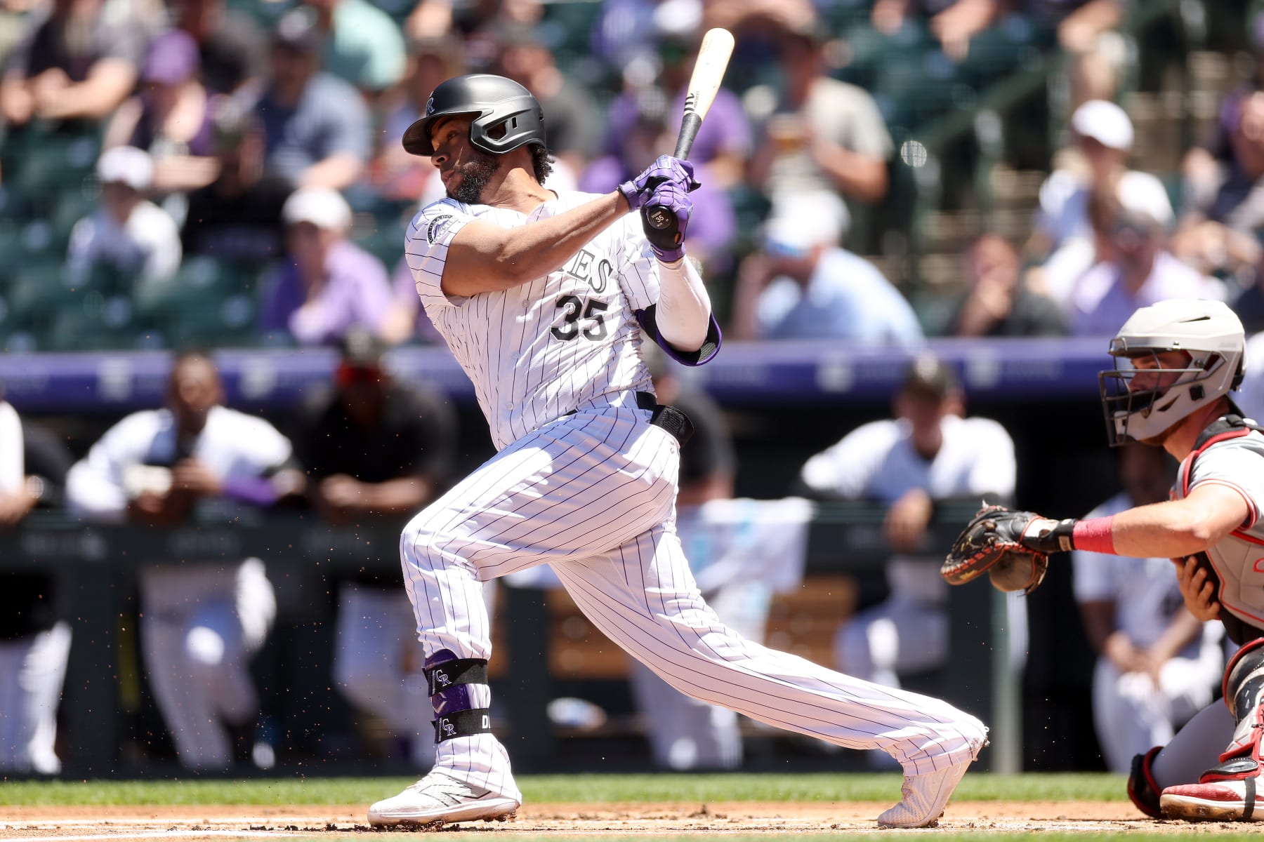 DENVER, COLORADO - JUNE 05: Elias Diaz #35 of the Colorado Rockies hits a ground out RBI against the Cincinnati Reds in the first inning at Coors Field on June 05, 2024 in Denver, Colorado. (Photo by Matthew Stockman/Getty Images)