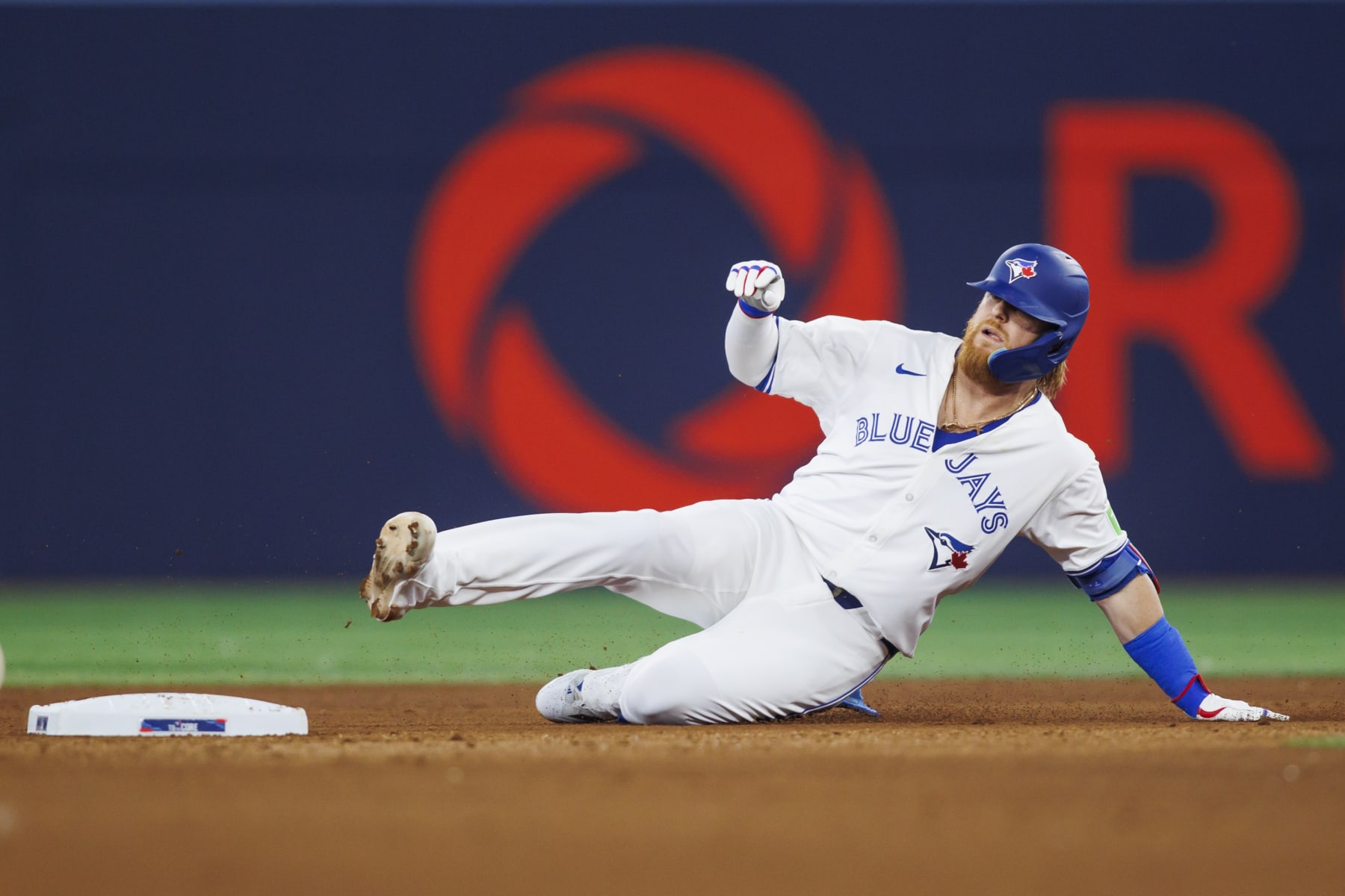 TORONTO, CANADA - JULY 26: Justin Turner #2 of the Toronto Blue Jays slides onto second base as he hits a double in the seventh inning of their MLB game against the Texas Rangers at Rogers Centre on July 26, 2024 in Toronto, Ontario, Canada. (Photo by Cole Burston/Getty Images)