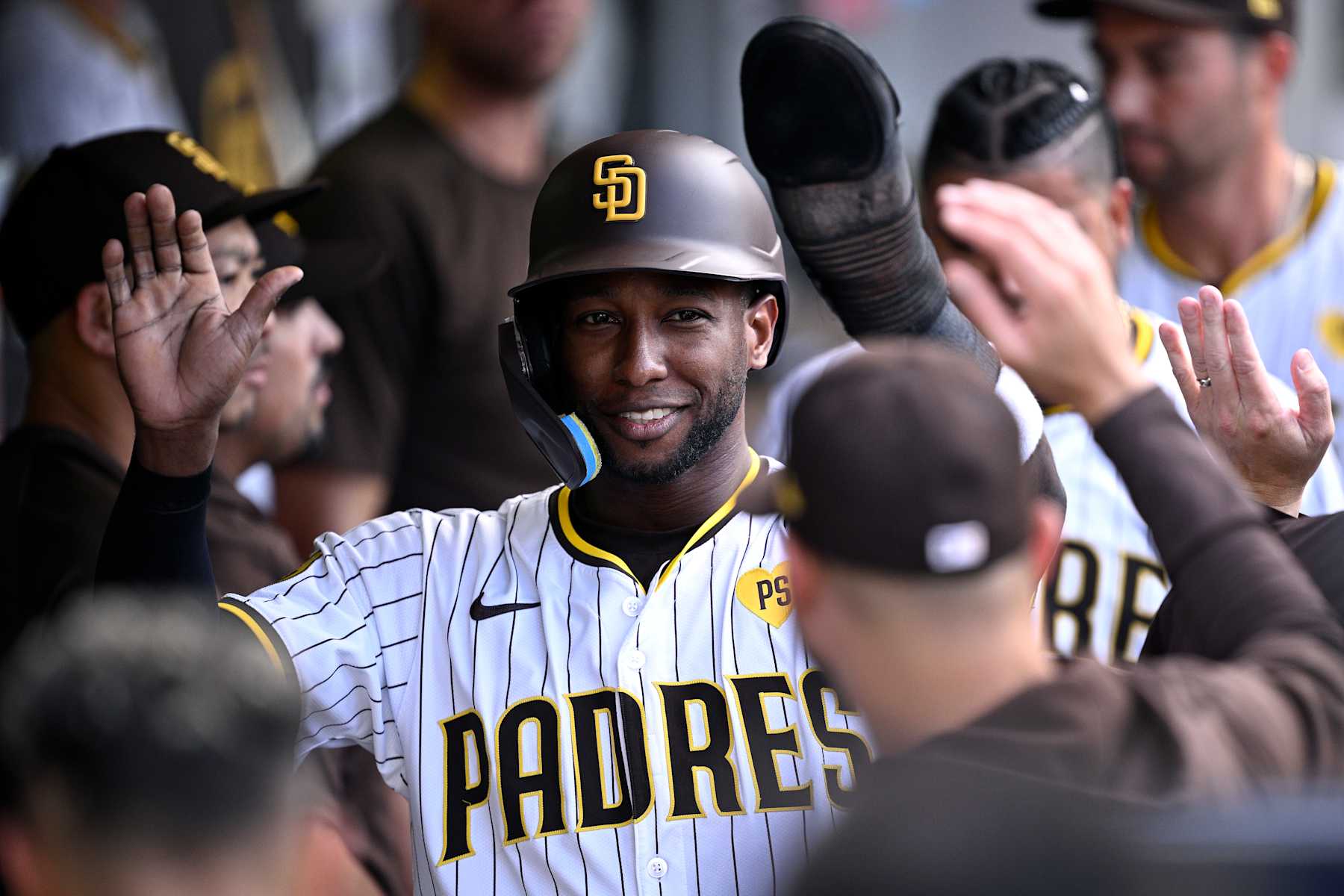 SAN DIEGO, CALIFORNIA - SEPTEMBER 07: Jurickson Profar #10 of the San Diego Padres is congratulated in the dugout after scoring a run against the San Francisco Giants during the first inning at Petco Park on September 07, 2024 in San Diego, California. (Photo by Orlando Ramirez/Getty Images)