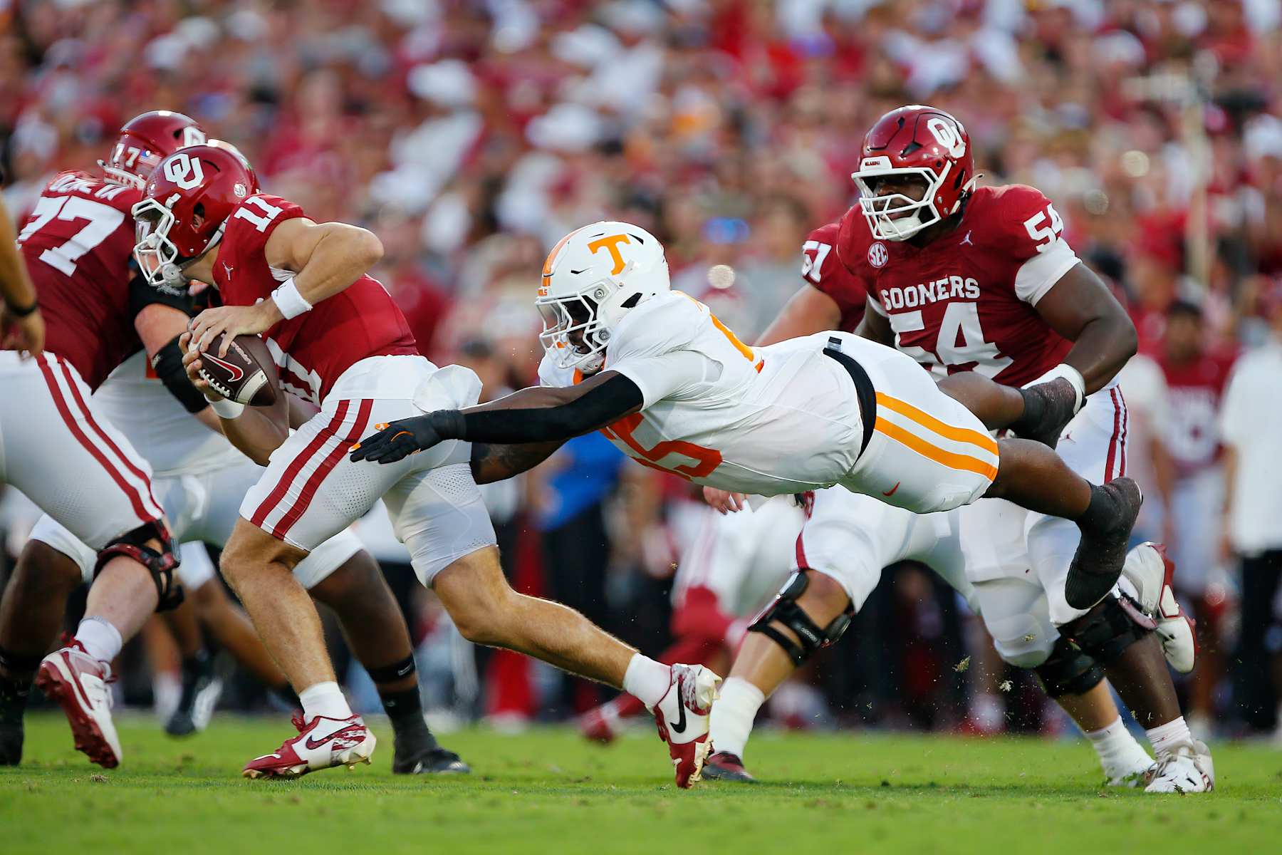 NORMAN, OKLAHOMA - SEPTEMBER 21:  Defensive lineman Omarr Norman-Lott #55 of the Tennessee Volunteers dives to catch quarterback Jackson Arnold #11 of the Oklahoma Sooners in the first quarter at Gaylord Family Oklahoma Memorial Stadium on September 21, 2024 in Norman, Oklahoma.  (Photo by Brian Bahr/Getty Images)
