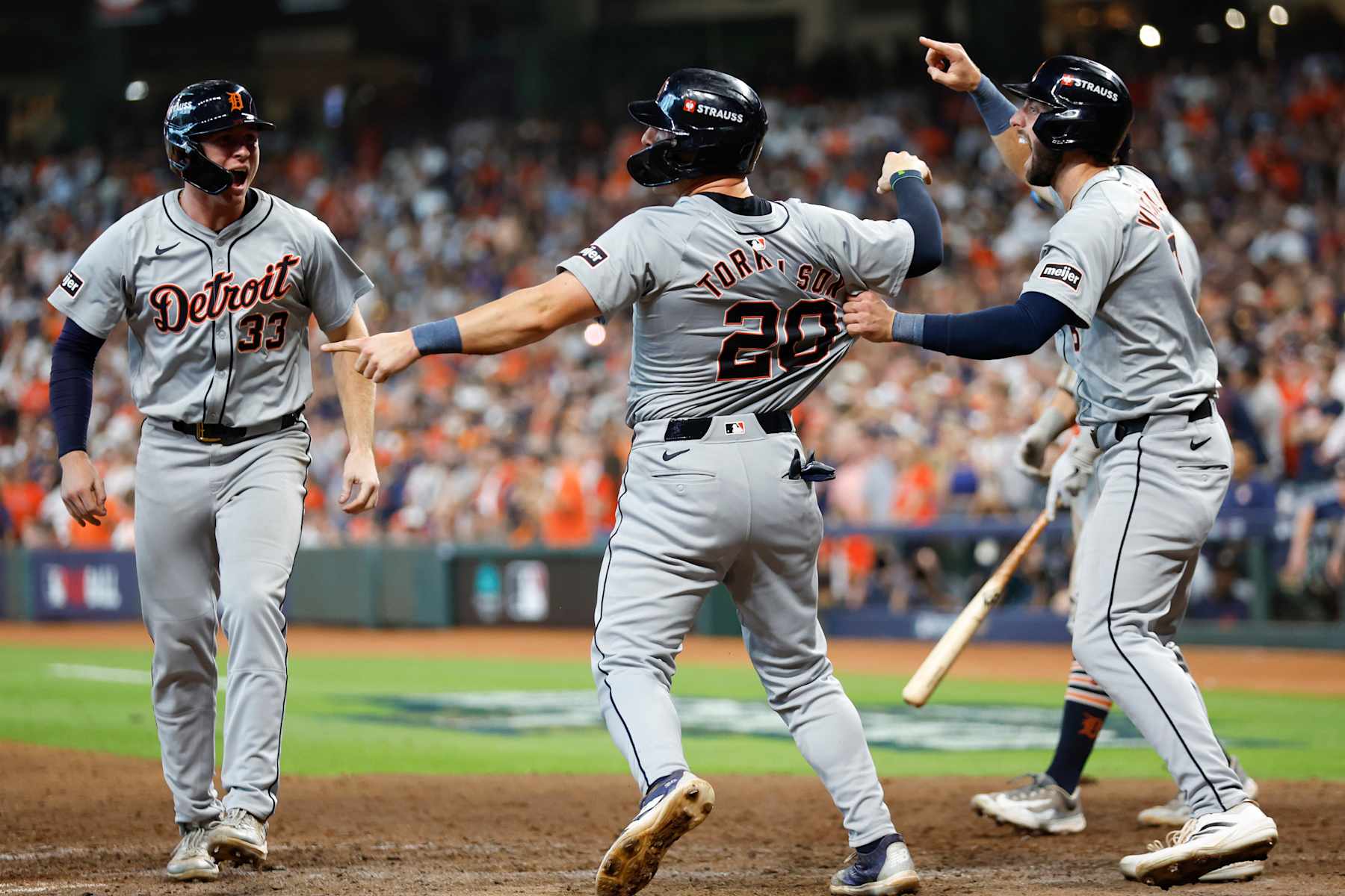 HOUSTON, TEXAS - OCTOBER 02: Spencer Torkelson #20 of the Detroit Tigers celebrates with teammate Matt Vierling #8 after scoring in the eighth inning against the Houston Astros during Game Two of the Wild Card Series at Minute Maid Park on October 02, 2024 in Houston, Texas.  (Photo by Tim Warner/Getty Images)
