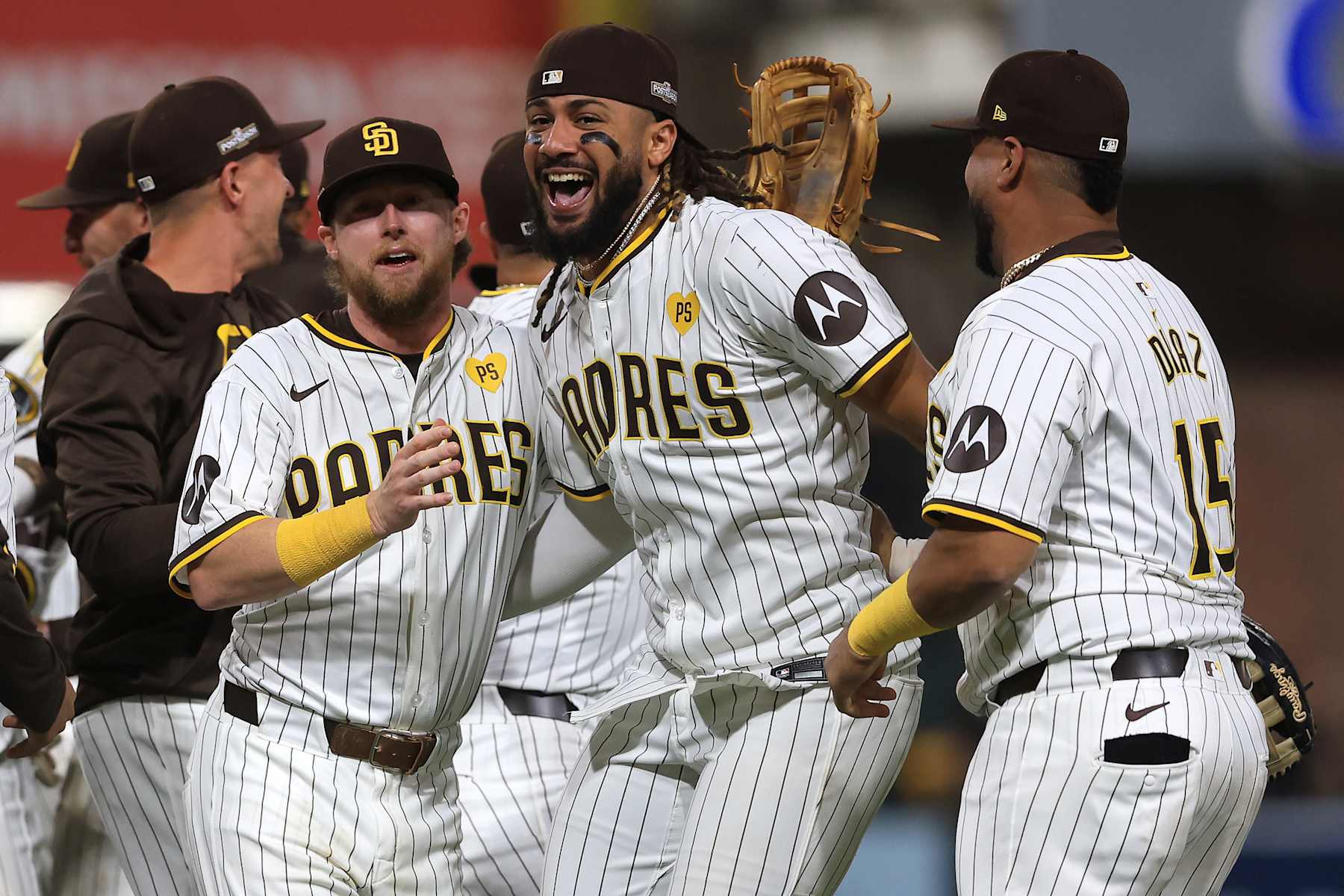 SAN DIEGO, CALIFORNIA - OCTOBER 02: Jake Cronenworth #9, Fernando Tatis Jr. #23 and Elias Díaz #15 of the San Diego Padres celebrate after defeating the Atlanta Braves in Game Two to win the Wild Card Series at Petco Park on October 02, 2024 in San Diego, California.  (Photo by Sean M. Haffey/Getty Images)