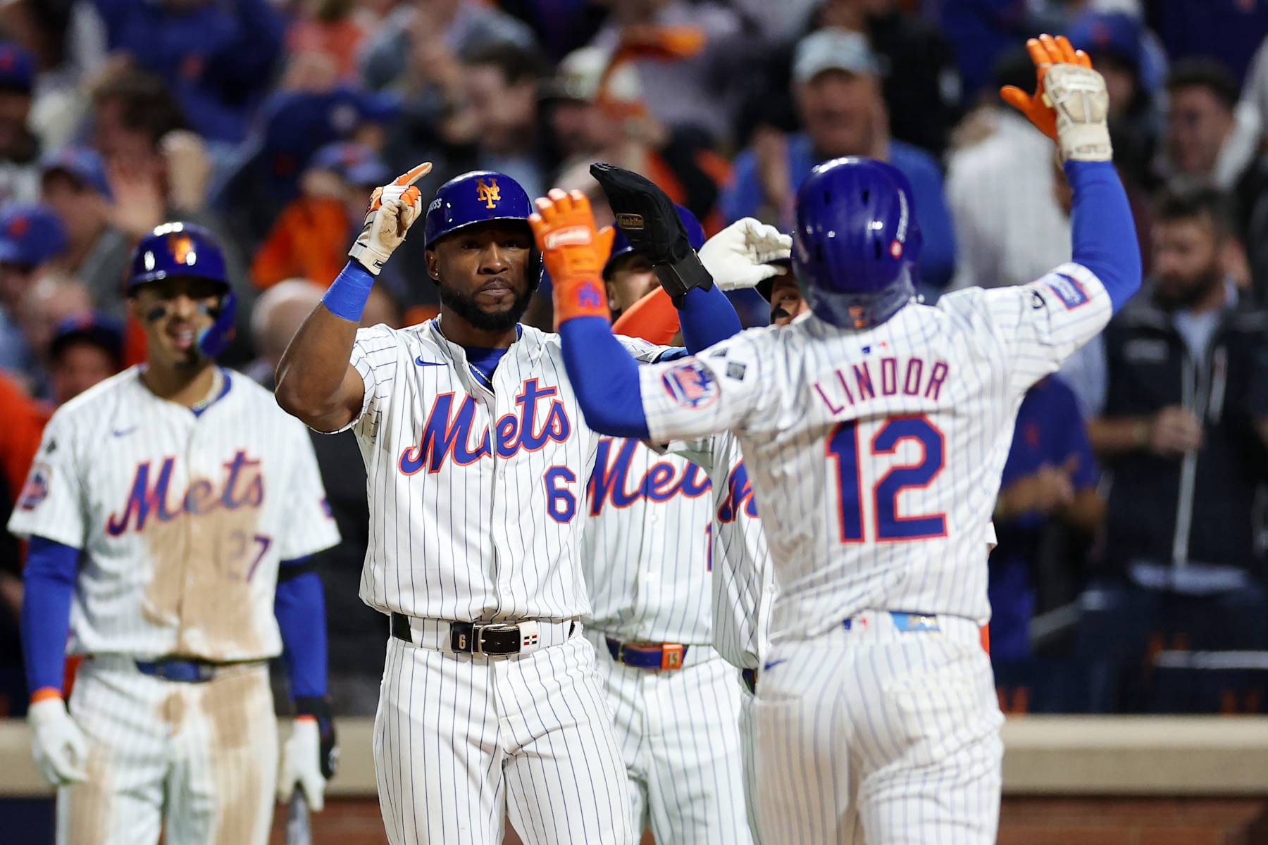 NEW YORK, NEW YORK - OCTOBER 09: Starling Marte #6 of the New York Mets greets Francisco Lindor #12 after Lindor hit a grand slam in the sixth inning against the Philadelphia Phillies during Game Four of the Division Series at Citi Field on October 09, 2024 in New York City. (Photo by Elsa/Getty Images)