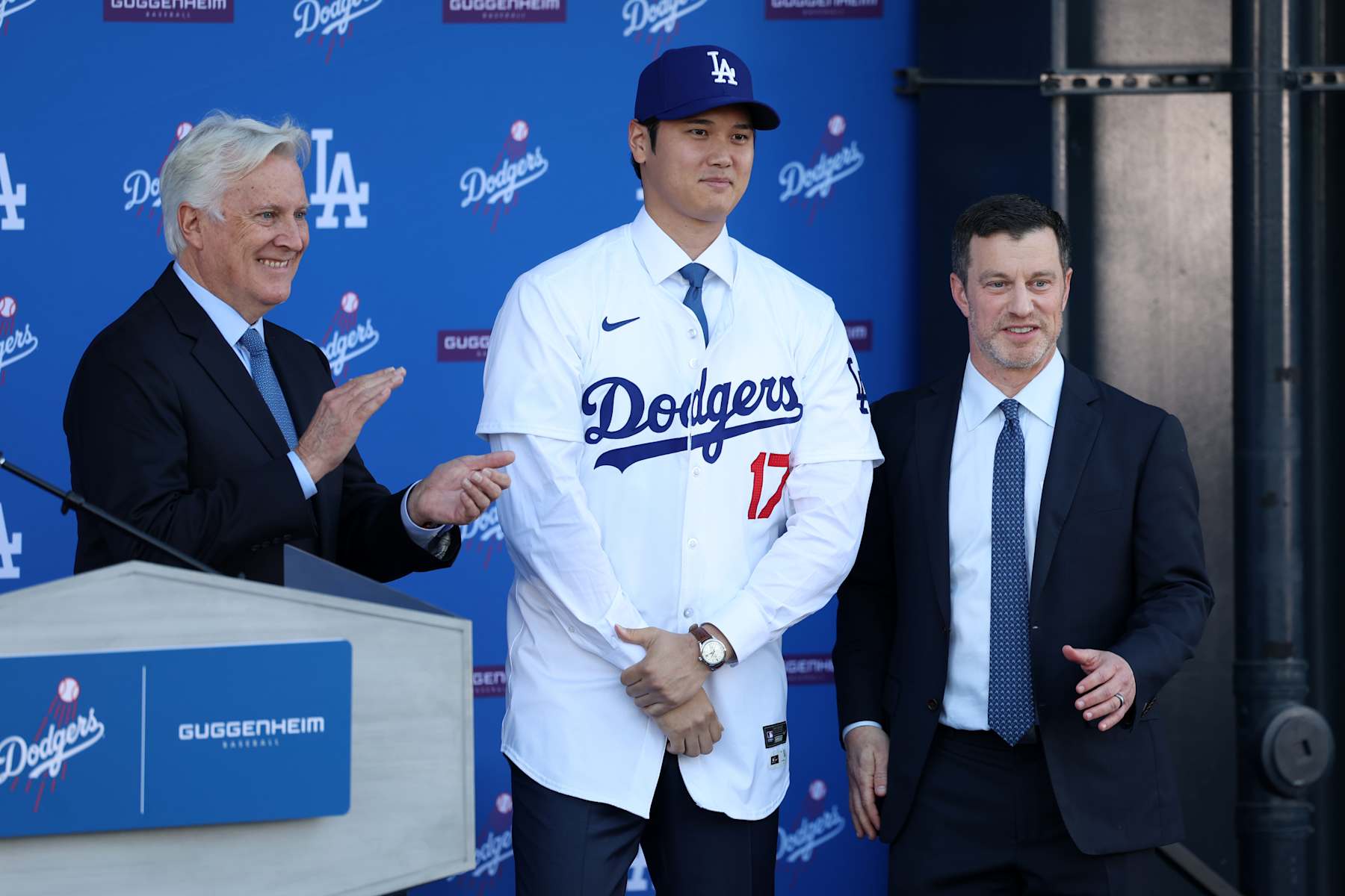 LOS ANGELES, CA - DECEMBER 14: Newly acquired Los Angeles Dodgers two-way player Shohei Ohtani (17) and the Los Angeles Dodgers owner Mark Walter (left) and President of Baseball Operations Andrew Friedman (right) at the introductory press conference on December 14, 2023 at Dodger Stadium in Los Angeles, CA.  (Photo by Kiyoshi Mio/Icon Sportswire via Getty Images)