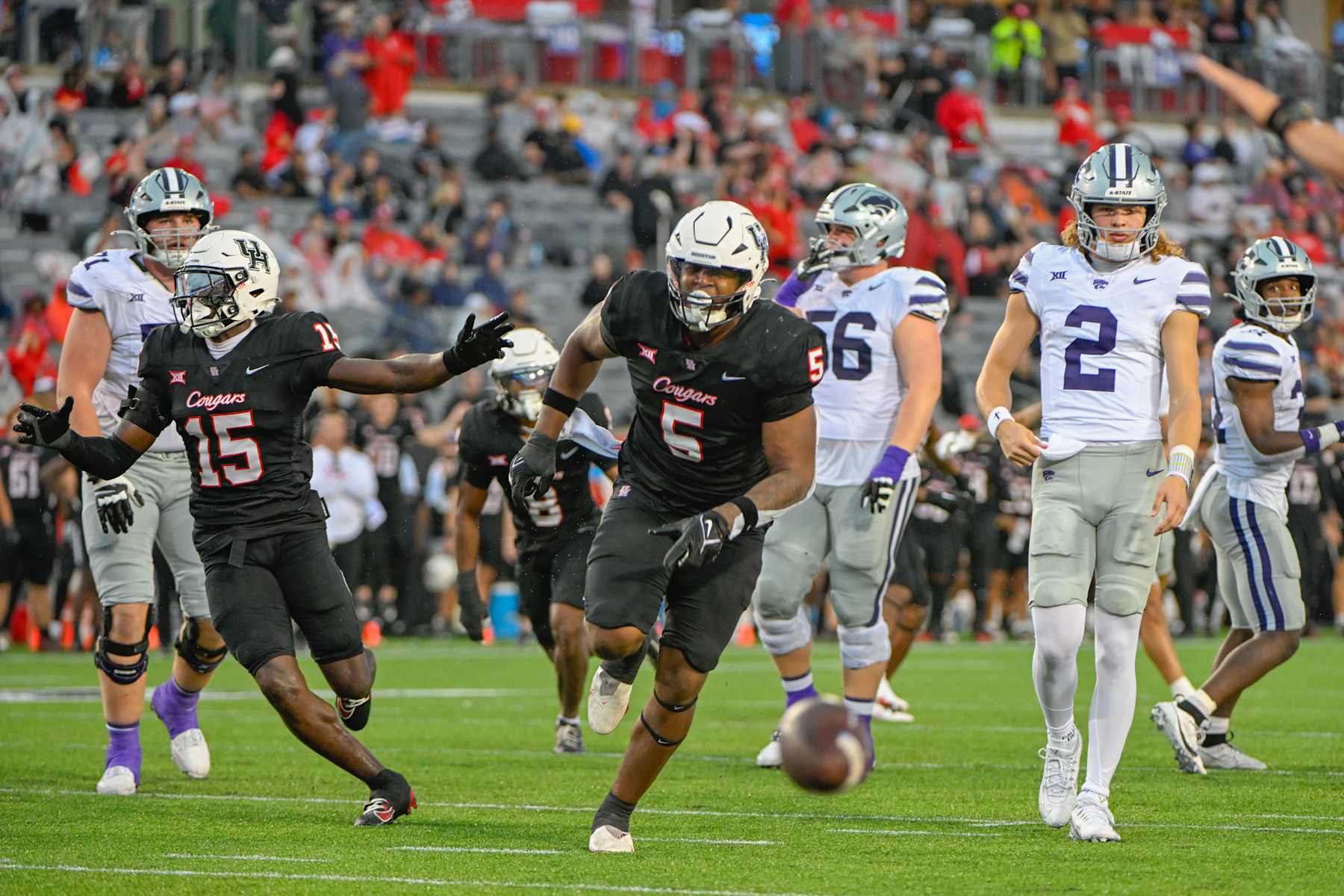 HOUSTON, CA - NOVEMBER 02: Houston Cougars defensive lineman Keith Cooper Jr. (5) celebrates his knocked down pass as Kansas State Wildcats quarterback Avery Johnson (2) looks on during first half action during the football game between the Kansas State Wildcats and Houston Cougars on November 2, 2024 at TDECU Stadium in Houston, Texas. (Photo by Ken Murray/Icon Sportswire via Getty Images) HOUSTON, CA - NOVEMBER 02: Houston Cougars defensive lineman Keith Cooper Jr. (5) celebrates his knocked down pass as Kansas State Wildcats quarterback Avery Johnson (2) looks on during first half action during the football game between the Kansas State Wildcats and Houston Cougars on November 2, 2024 at TDECU Stadium in Houston, Texas. (Photo by Ken Murray/Icon Sportswire via Getty Images)